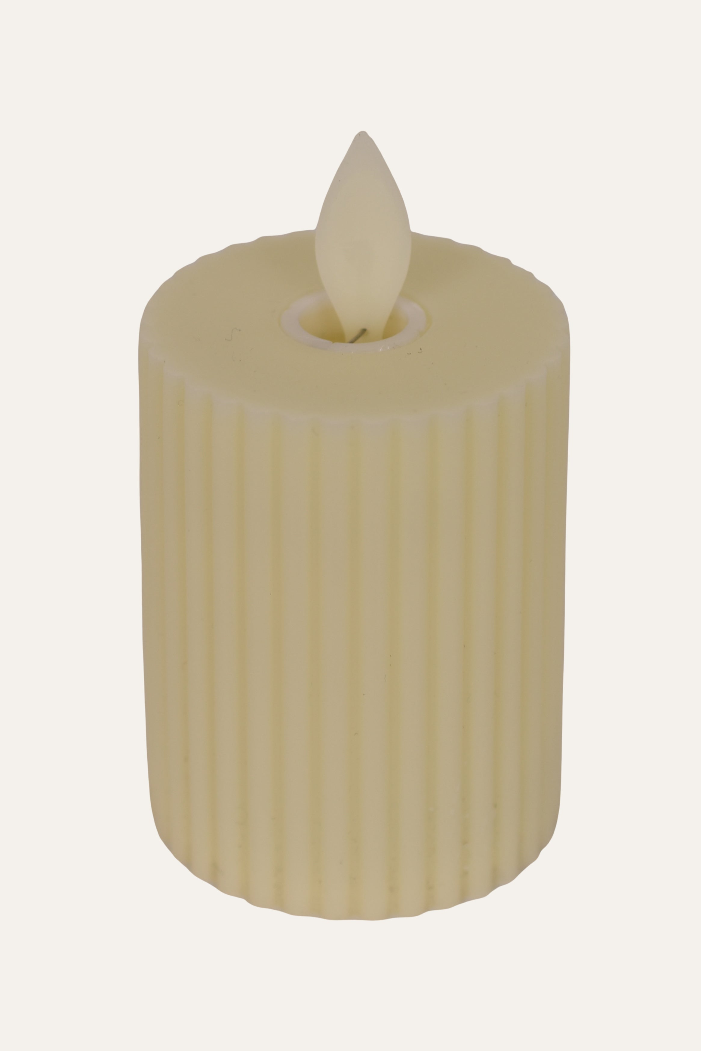 Beige candle with a ribbed texture