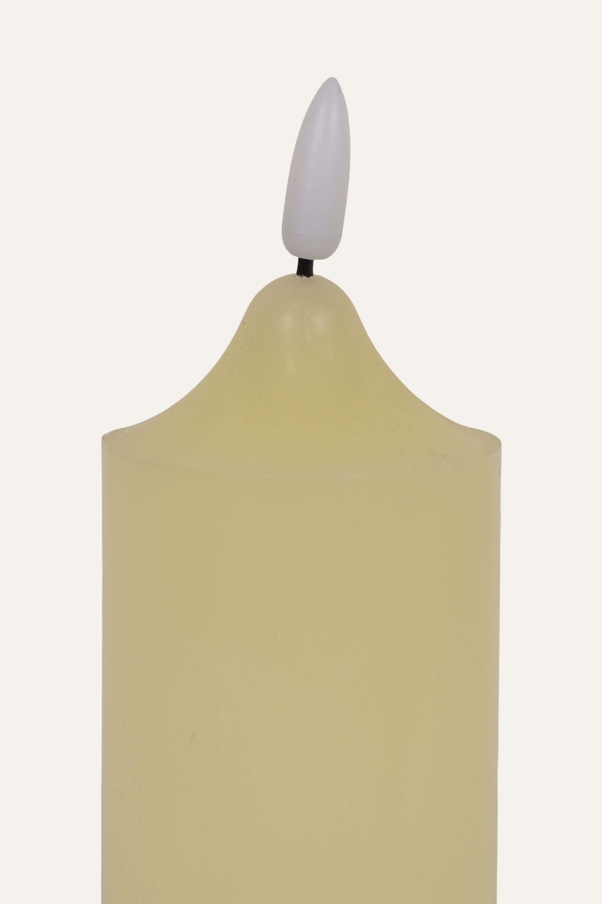 Beige candle with a white wick