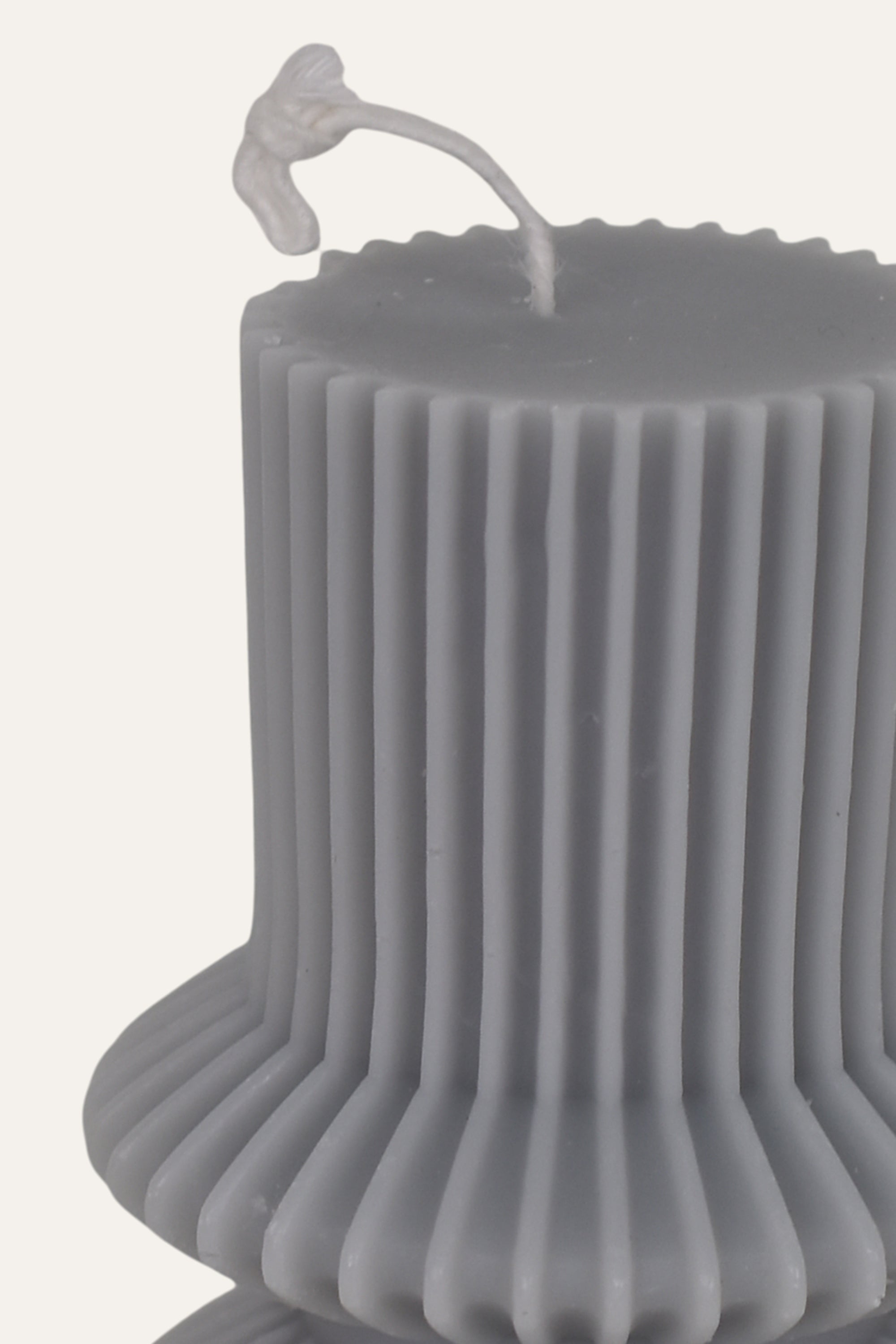 Gray textured candle with ribbed design