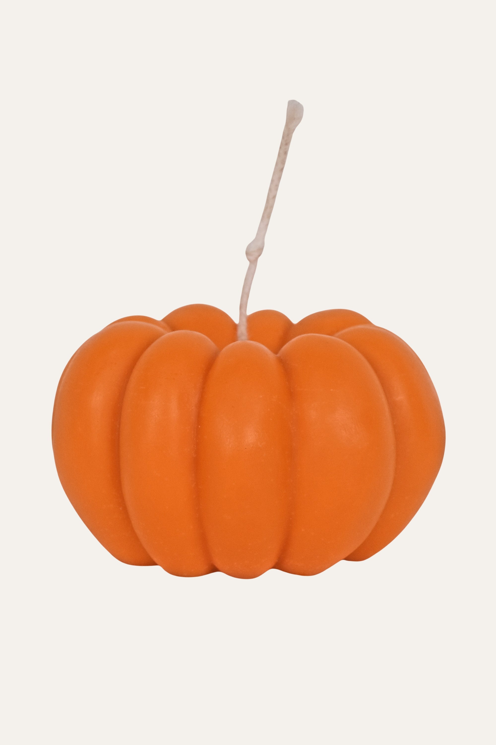 Orange pumpkin-shaped candle