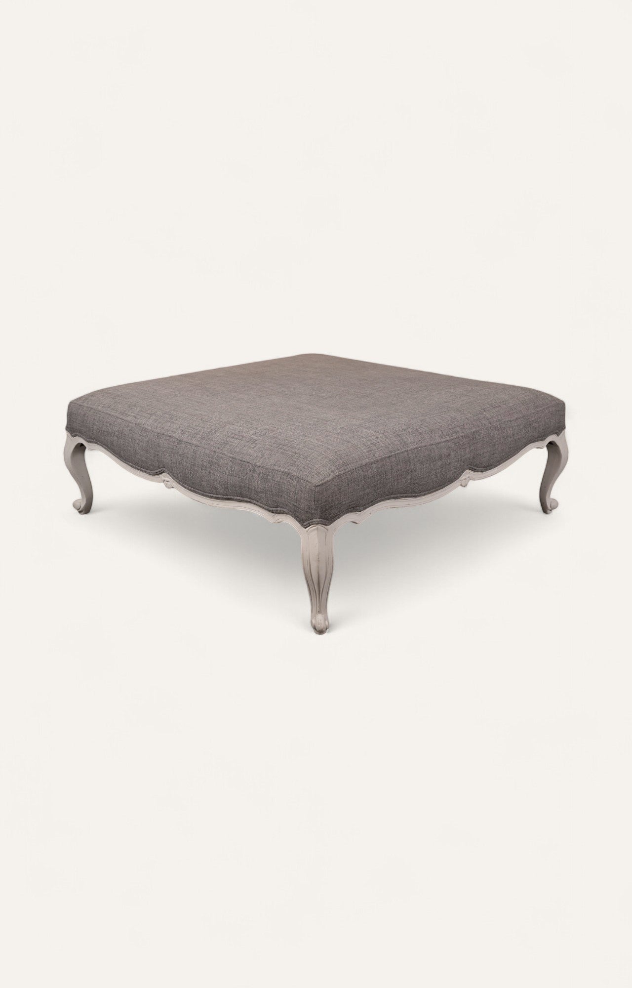 Elegant Gray Ottoman with Sculpted Wooden Legs