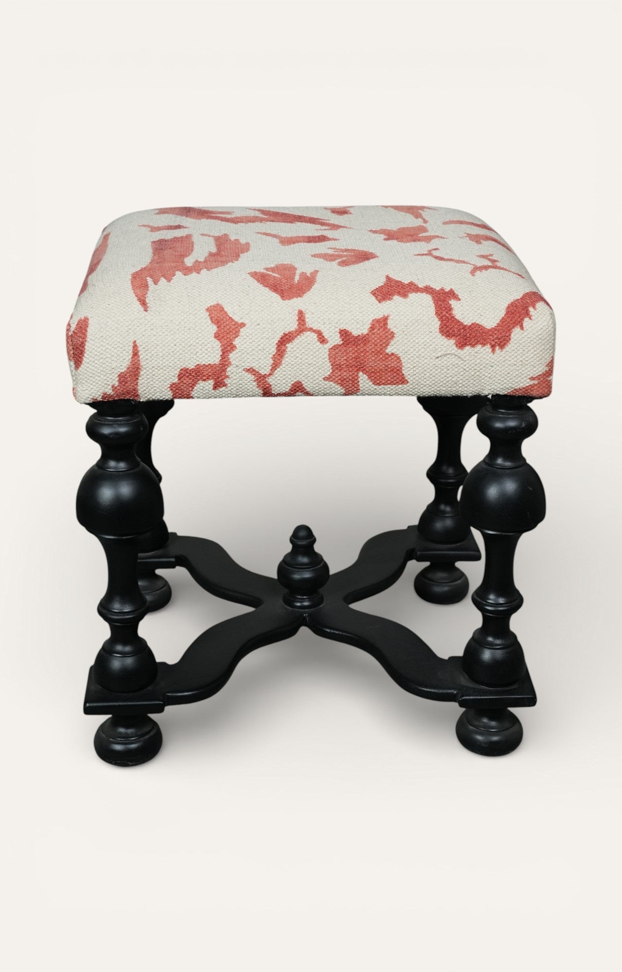Upholstered Stool with Sculpted Black Base