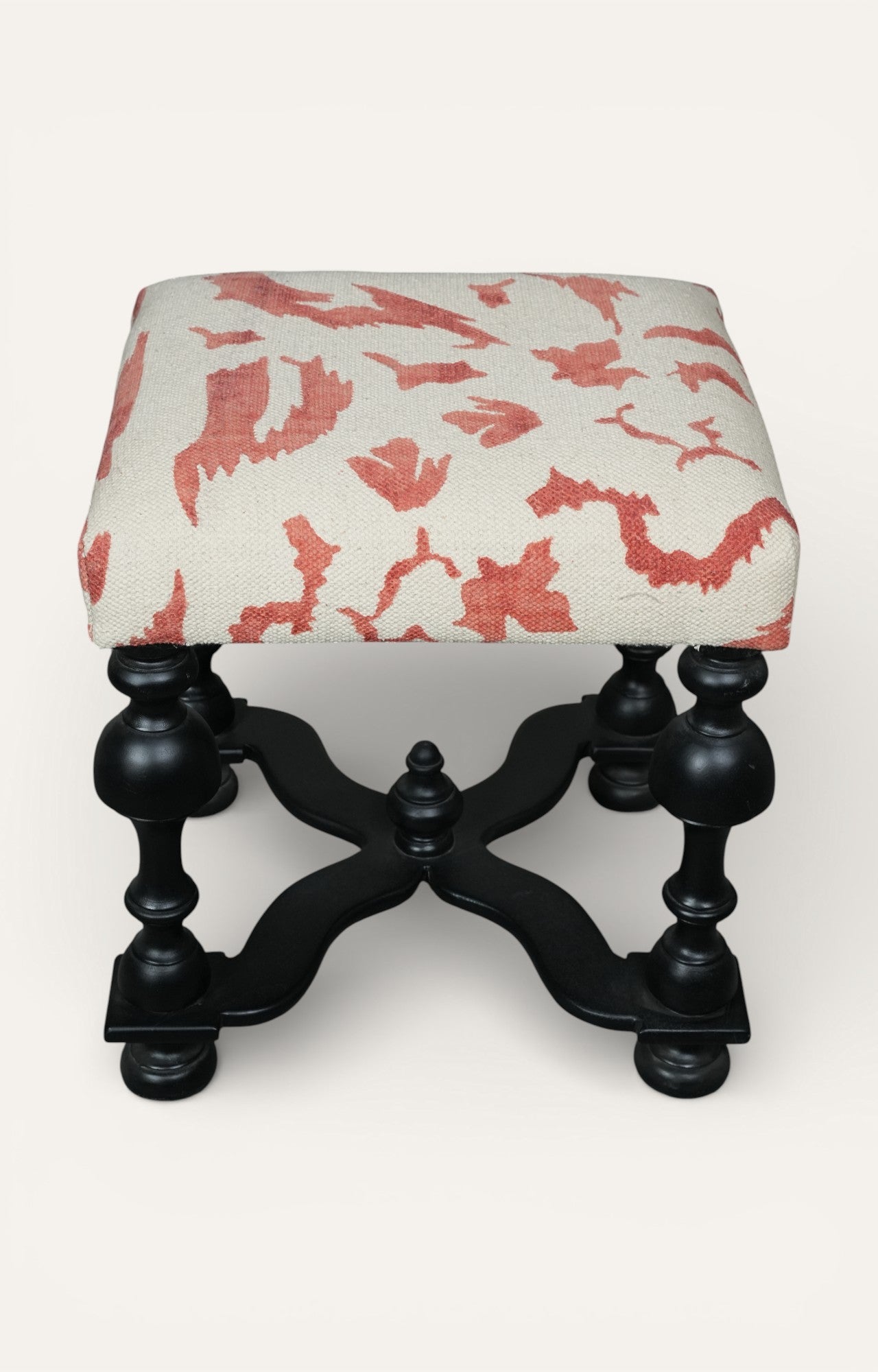 Upholstered Stool with Sculpted Black Base