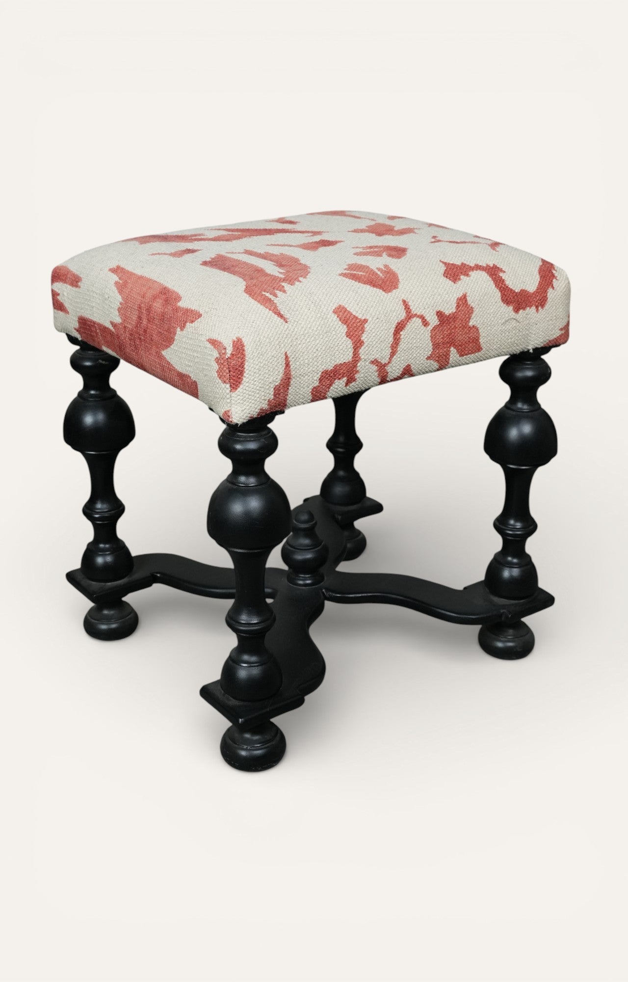 Upholstered Stool with Sculpted Black Base