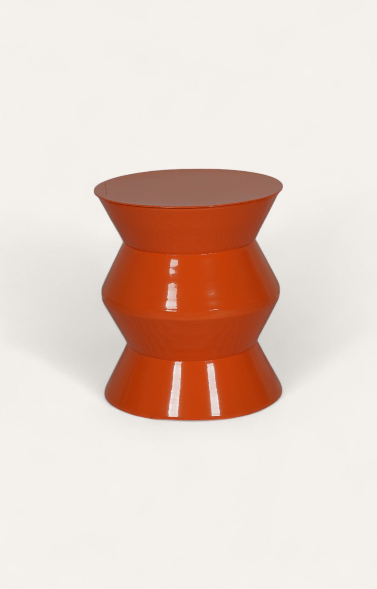 Sculptural orange metal side table in a striking zig-zag design.