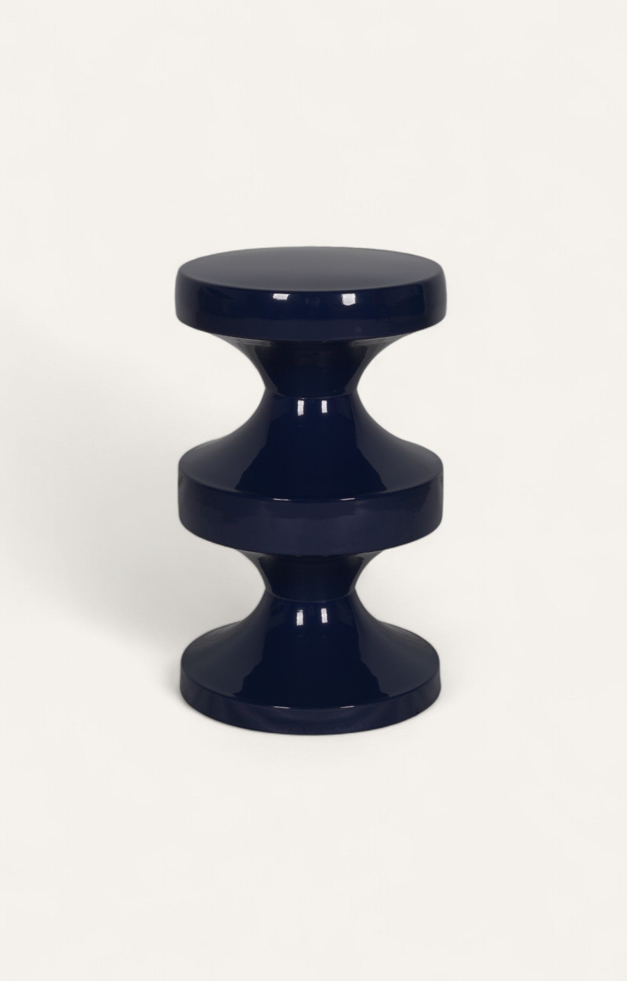 Glossy teal metal table with sculptural tiered design and lacquer finish.