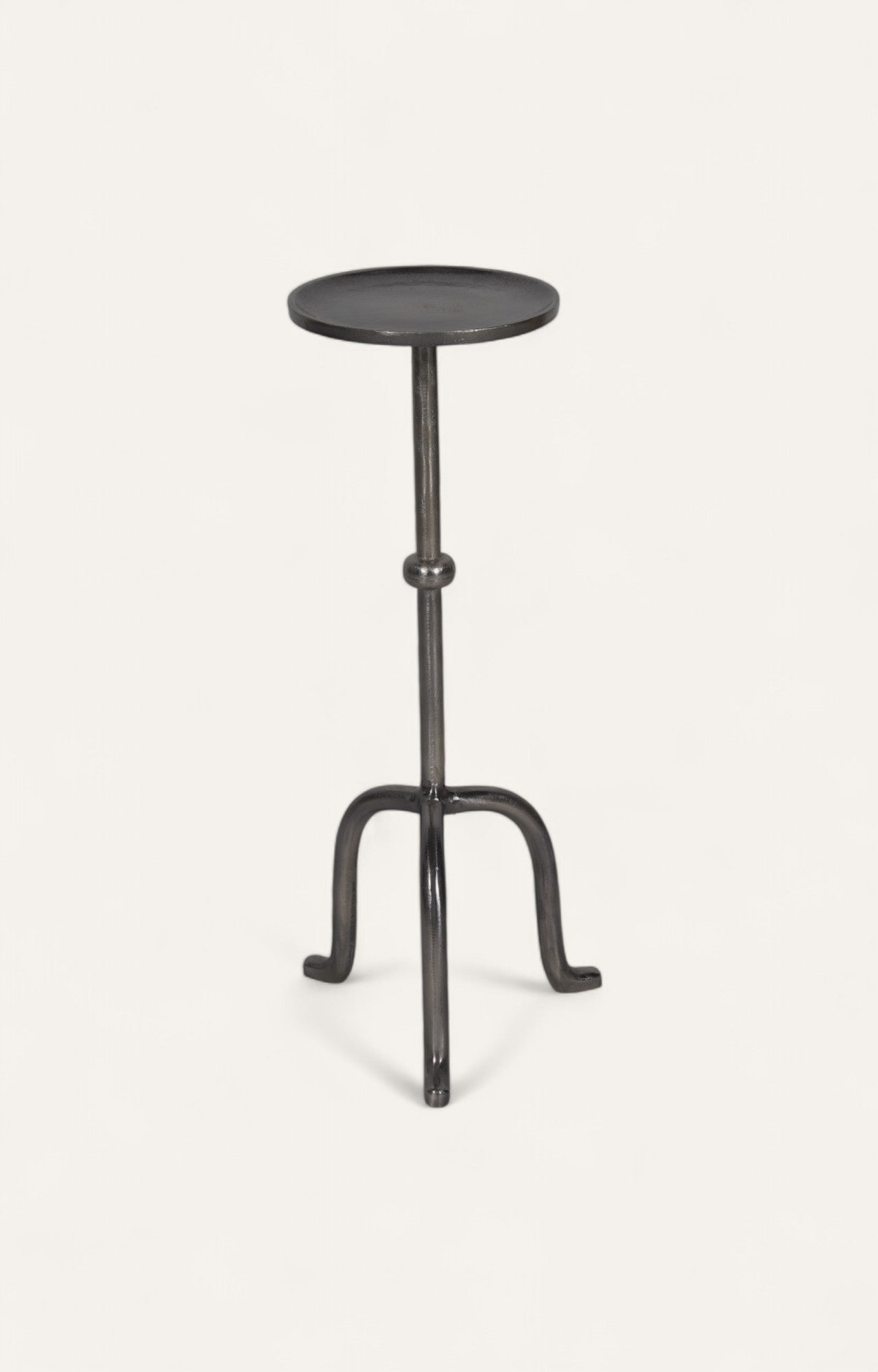 Black tripod peg table in metal with slender industrial shape.