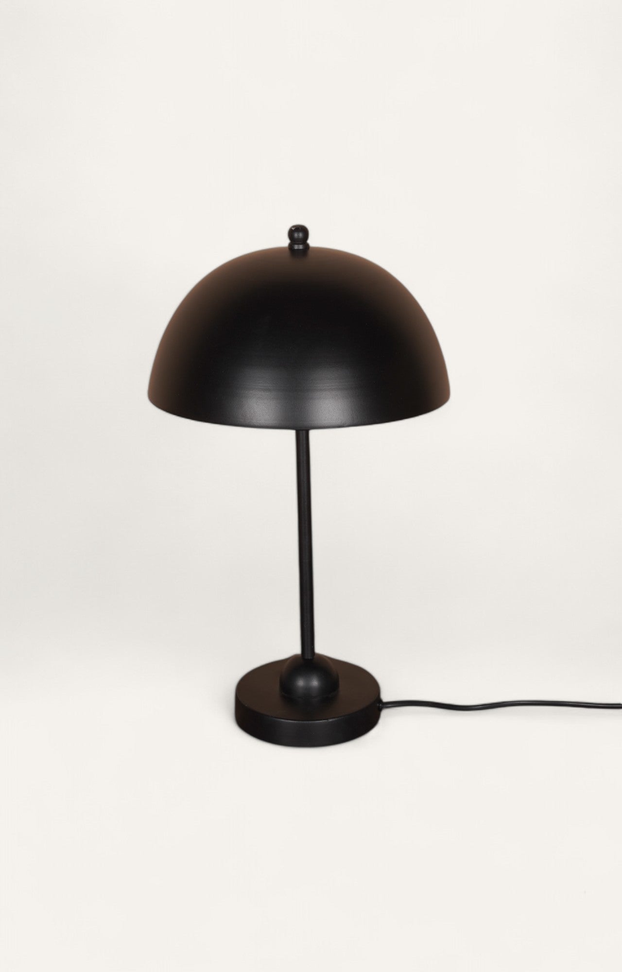 Modern black metal table lamp with a dome lamp shade.