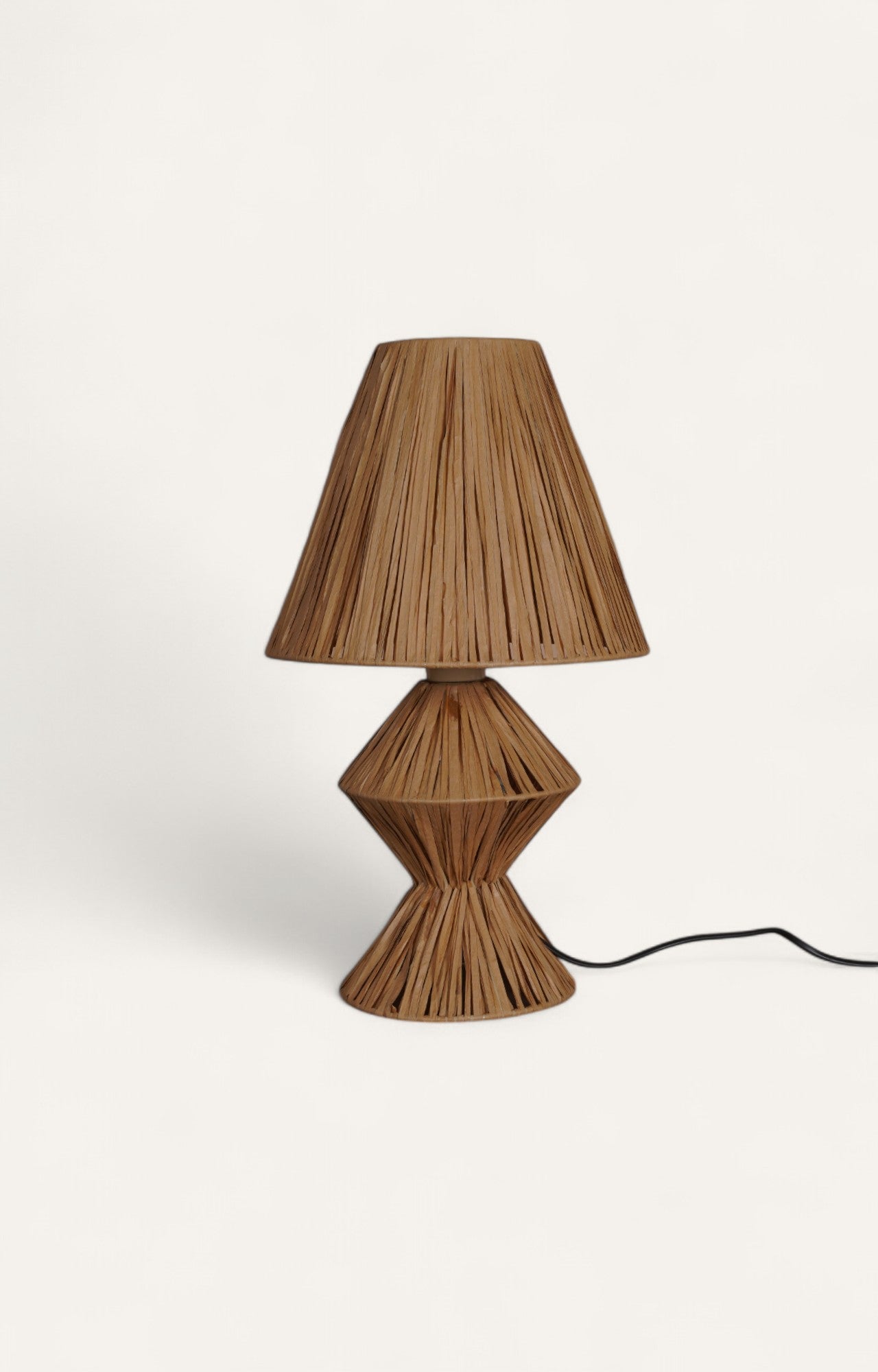Table lamp with natural raffia ropes wrapped in a geometric hourglass shape for the base and a conical shade.