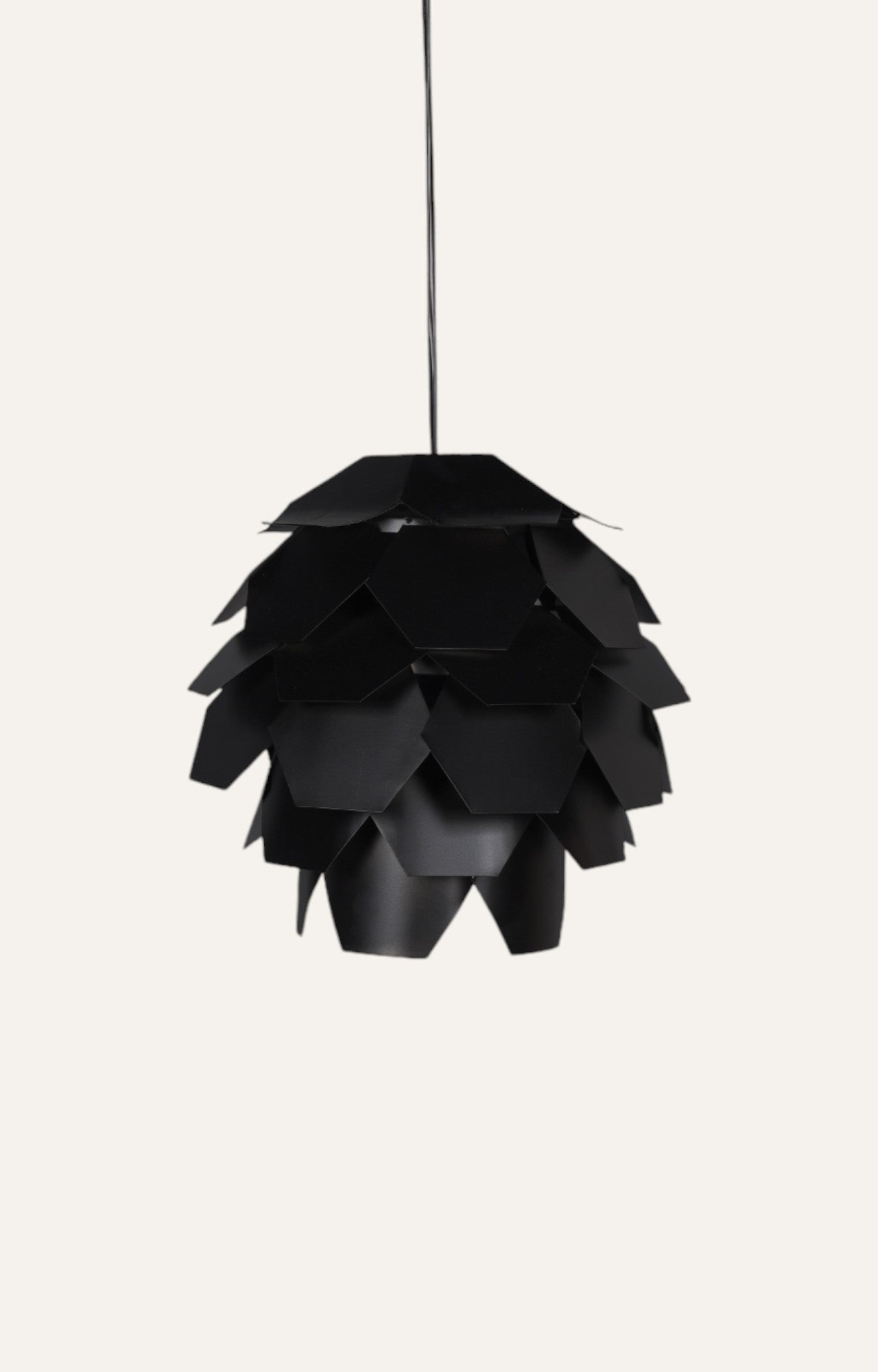 Pendant light with a sculptural artichoke-like design made of black metal layers.
