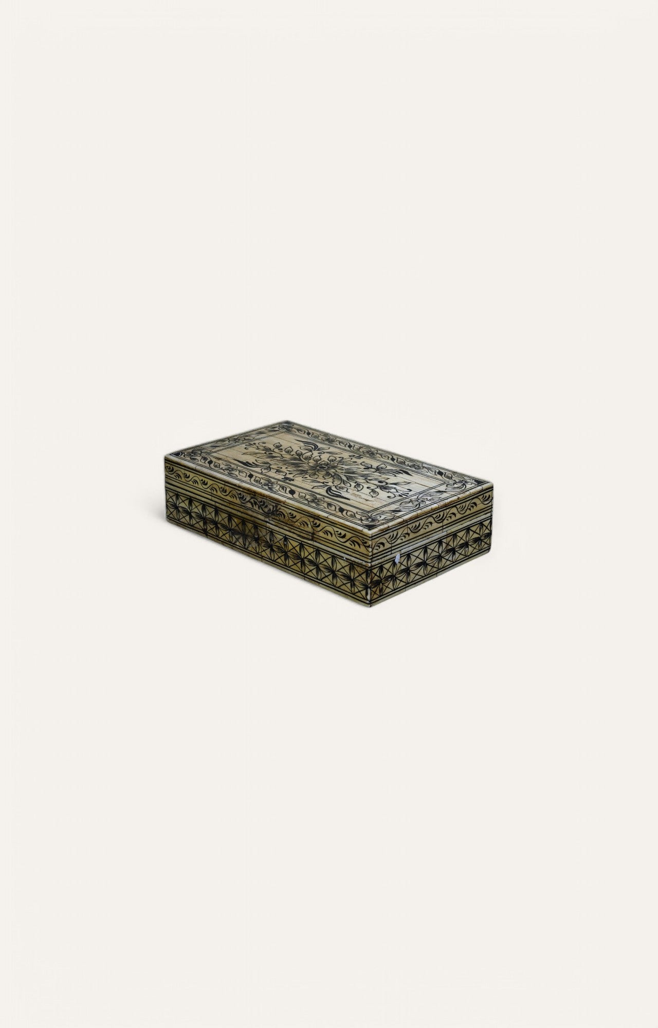 Hand-painted rectangular bone box with floral top and star-like geometric detailing on sides.