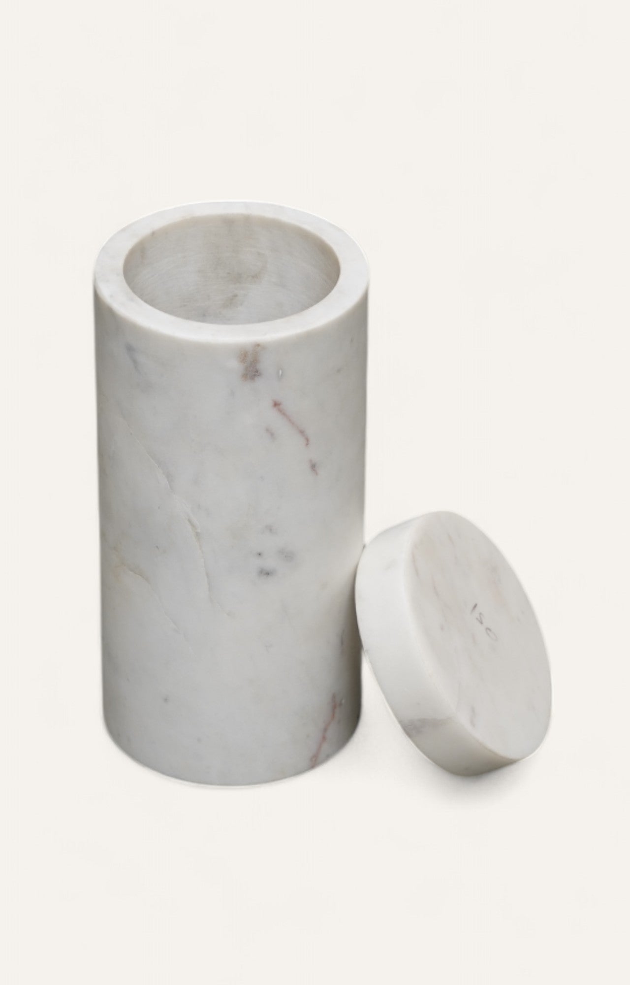 Cylindrical white marble box with separate round lid and soft veining