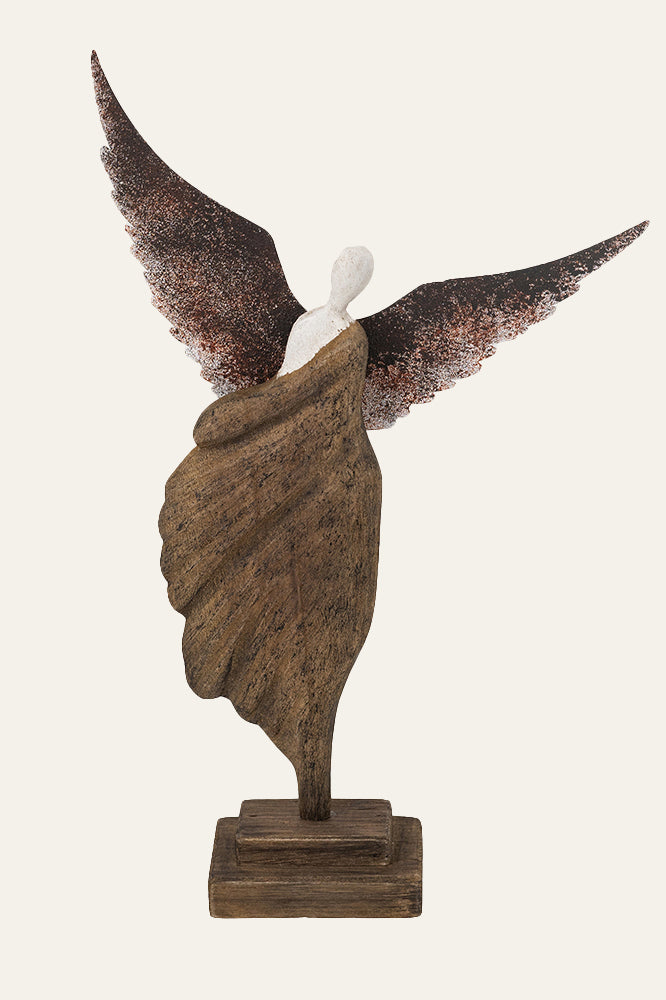 Decorative winged angel statue on pedestal