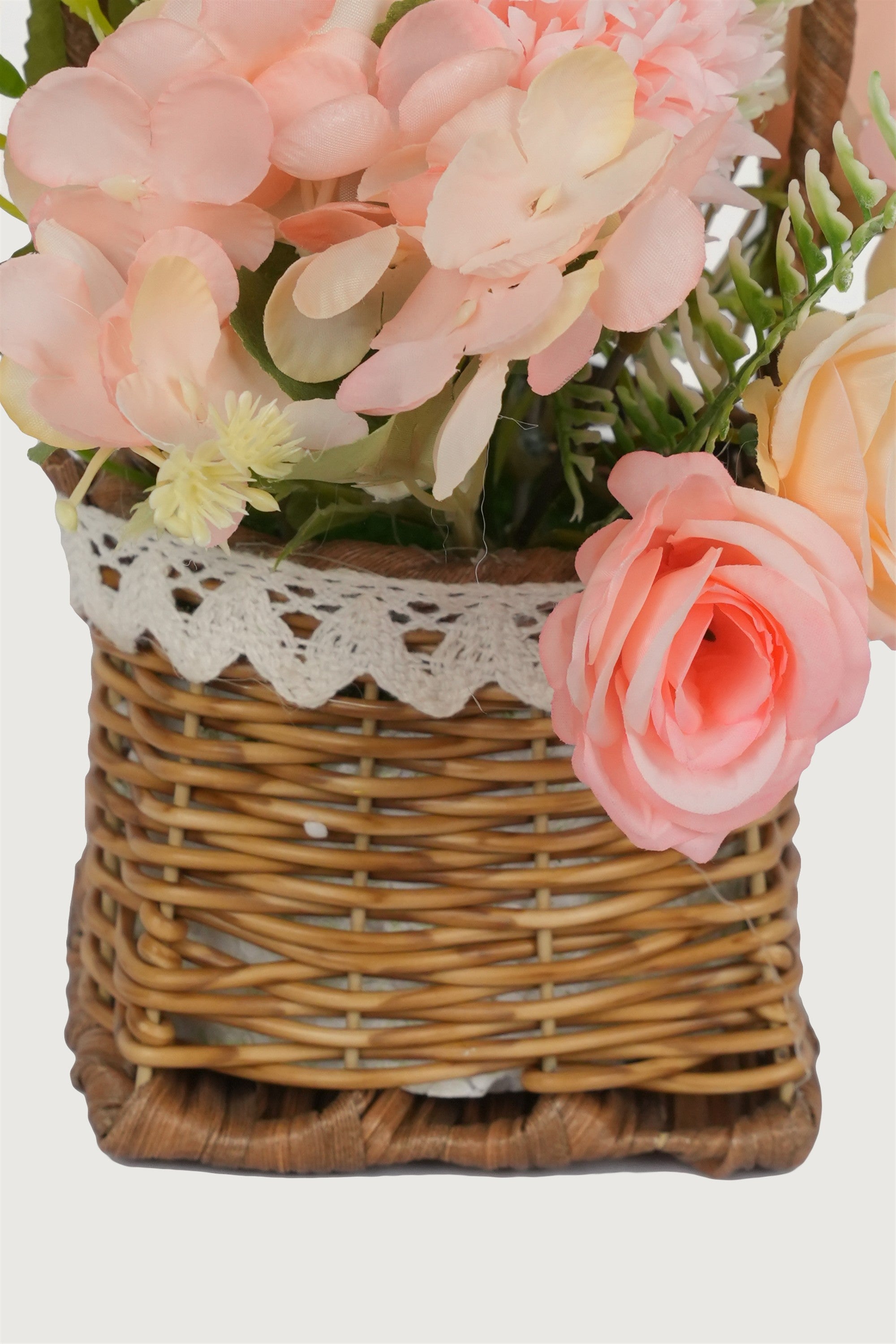 Faux flowers in woven basket