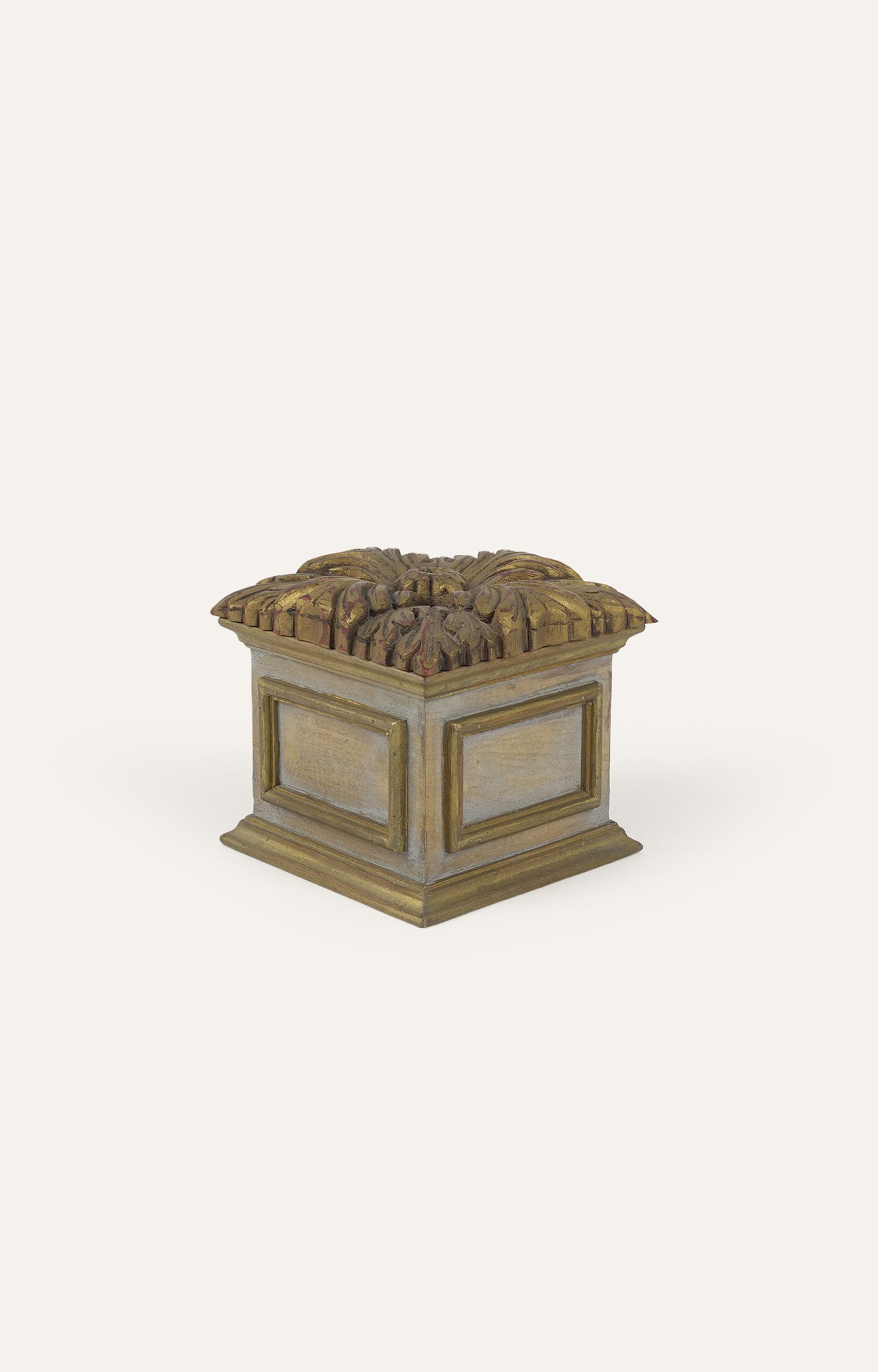 Small, square, dark wooden box with an intricately carved design on its lid.