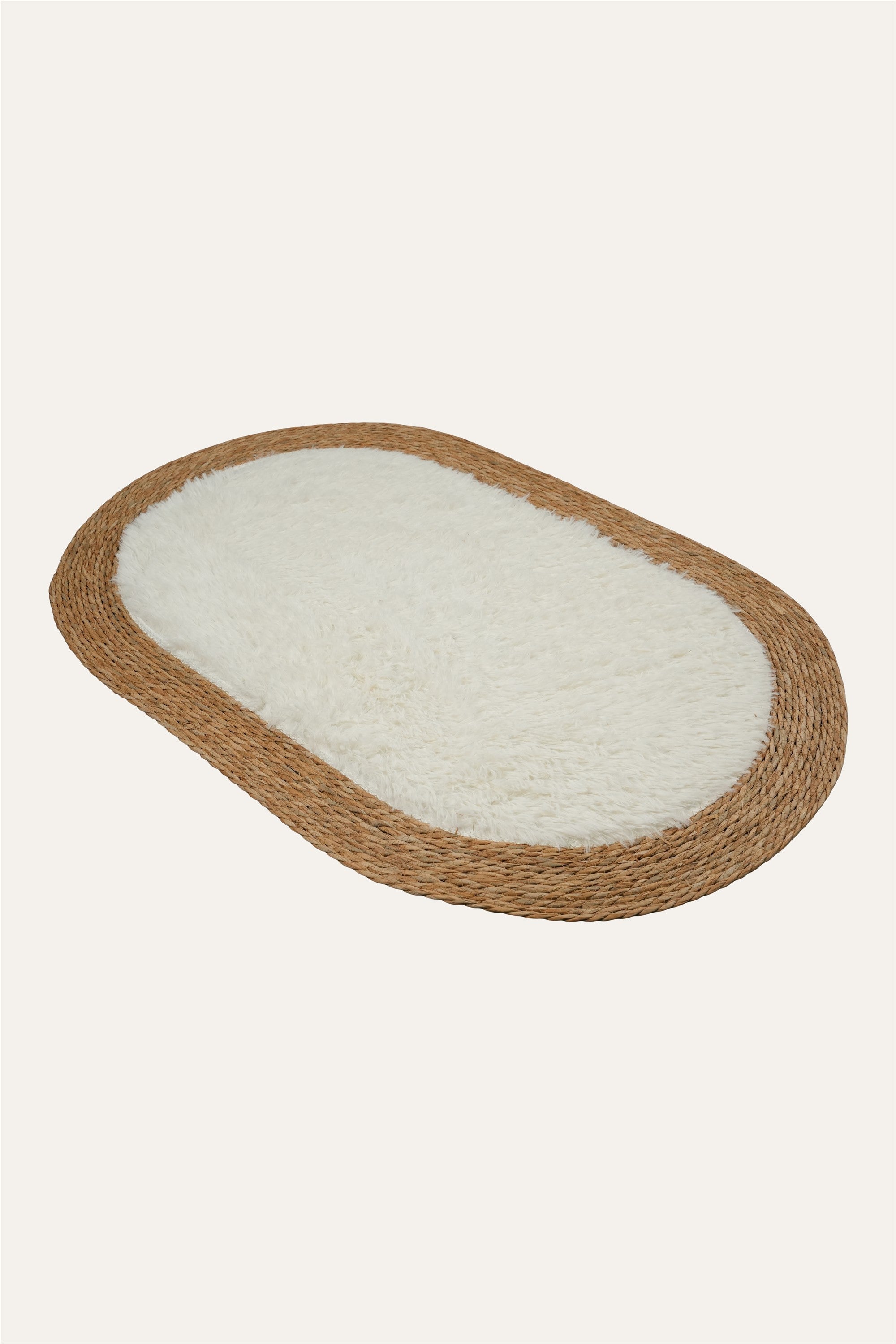 Handwoven oval natural fiber floor mat