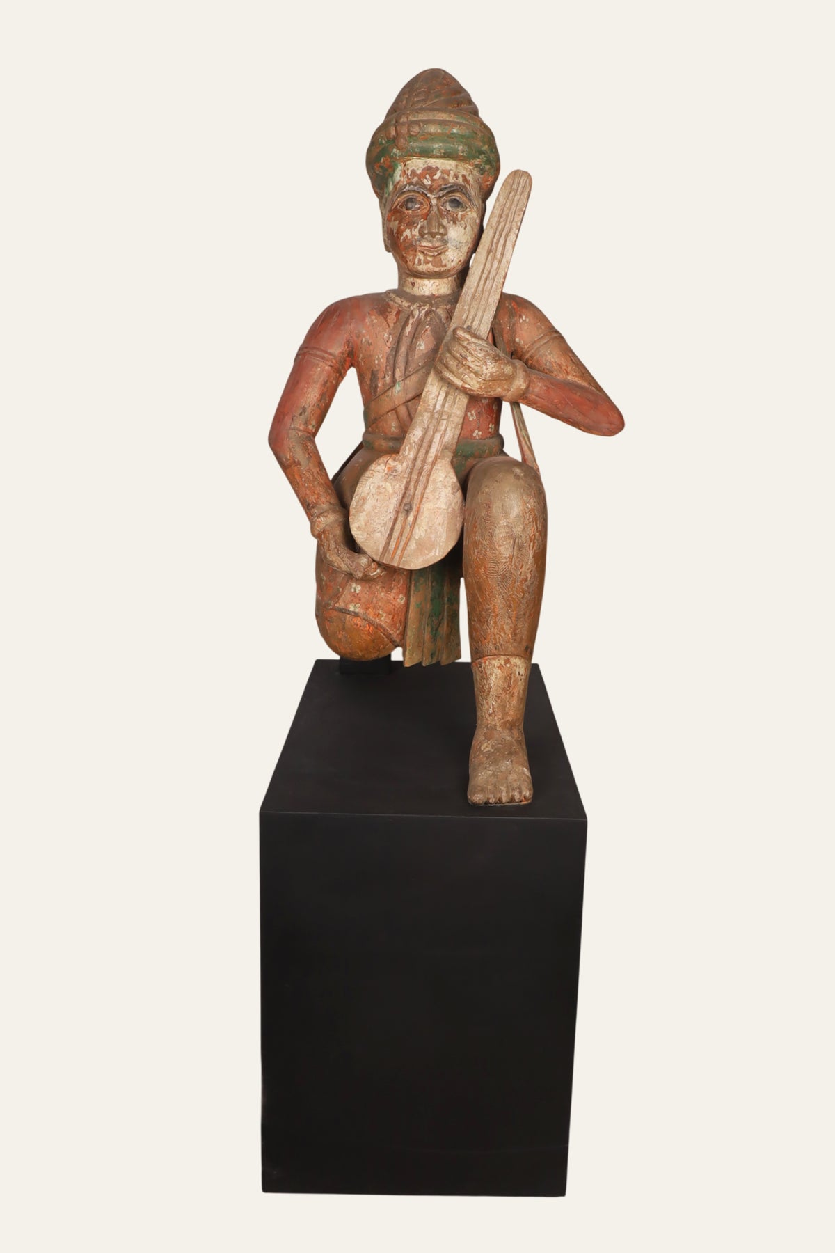 Indian musician statue on gallery pedestal
