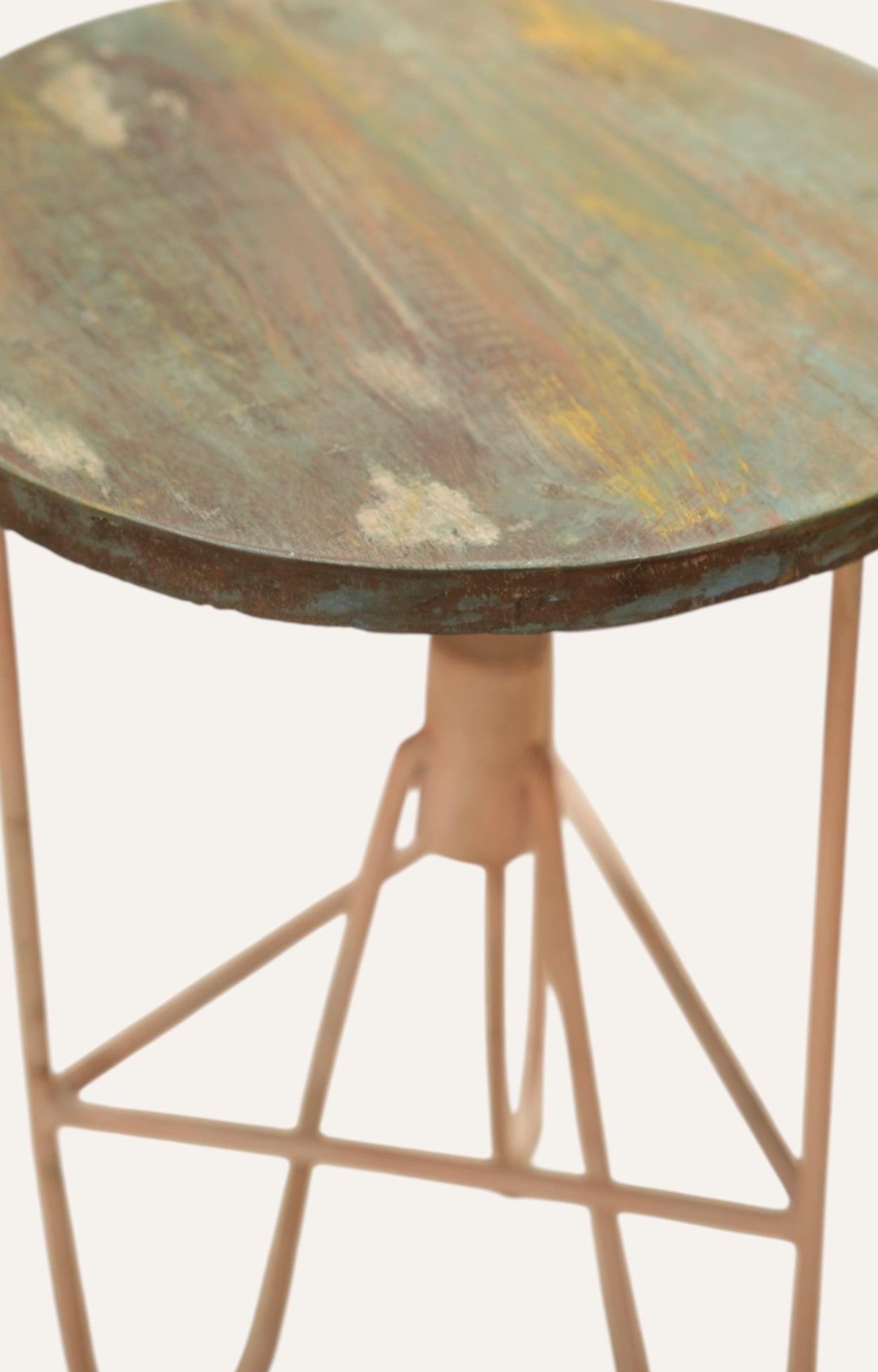Round metal table with a distressed finish