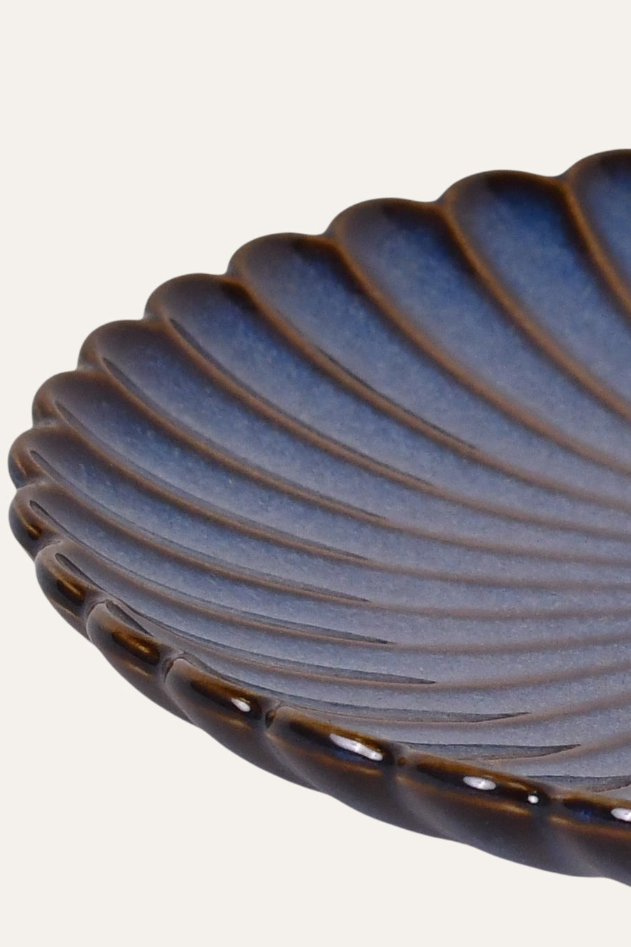 Small ceramic plate with ribbed texture design