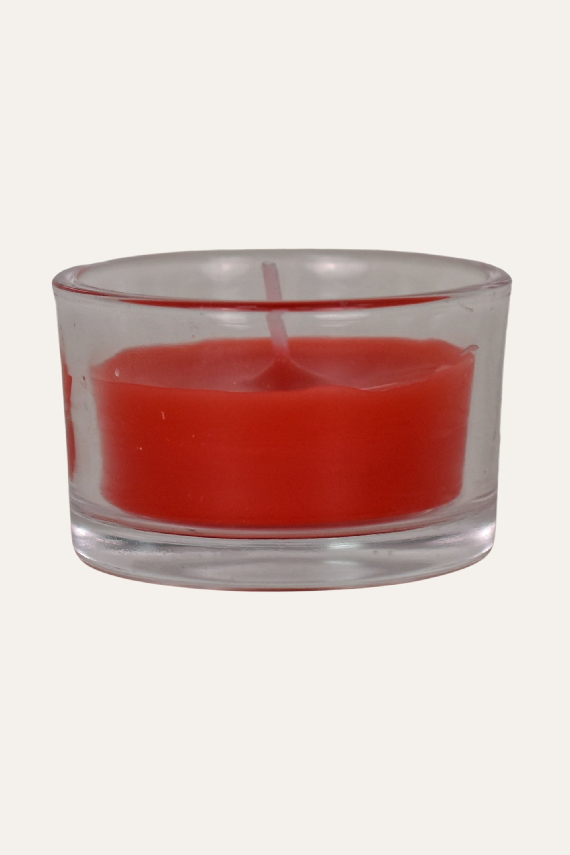 Red candle in a clear glass holder