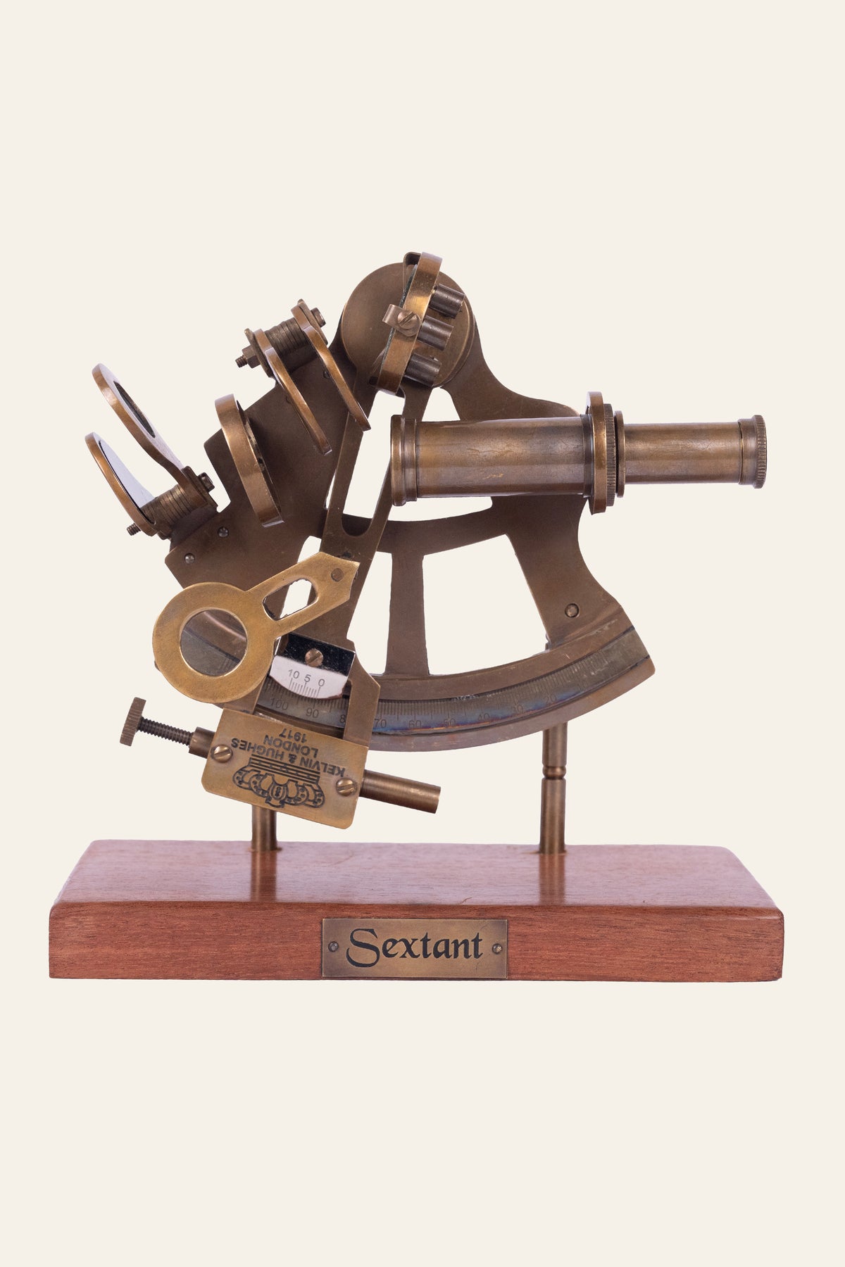 antique sextant on wooden base