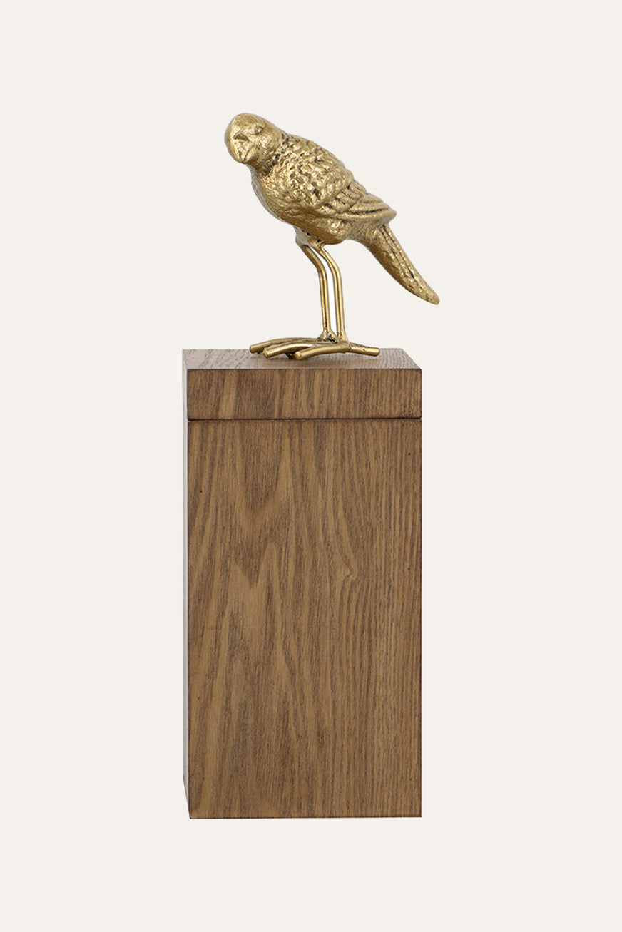 bird sculpture on wooden pedestal