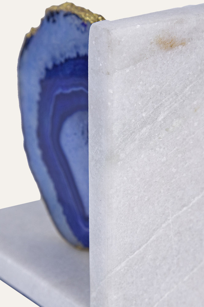 blue agate bookends set on a white marble base