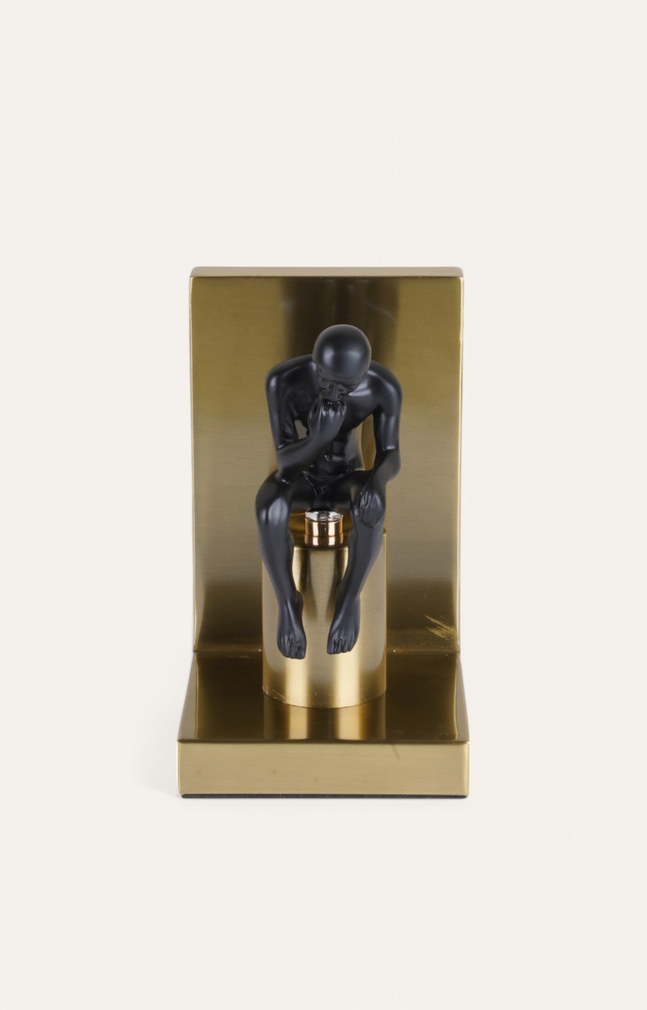 bookend set with golden base and matte black figure
