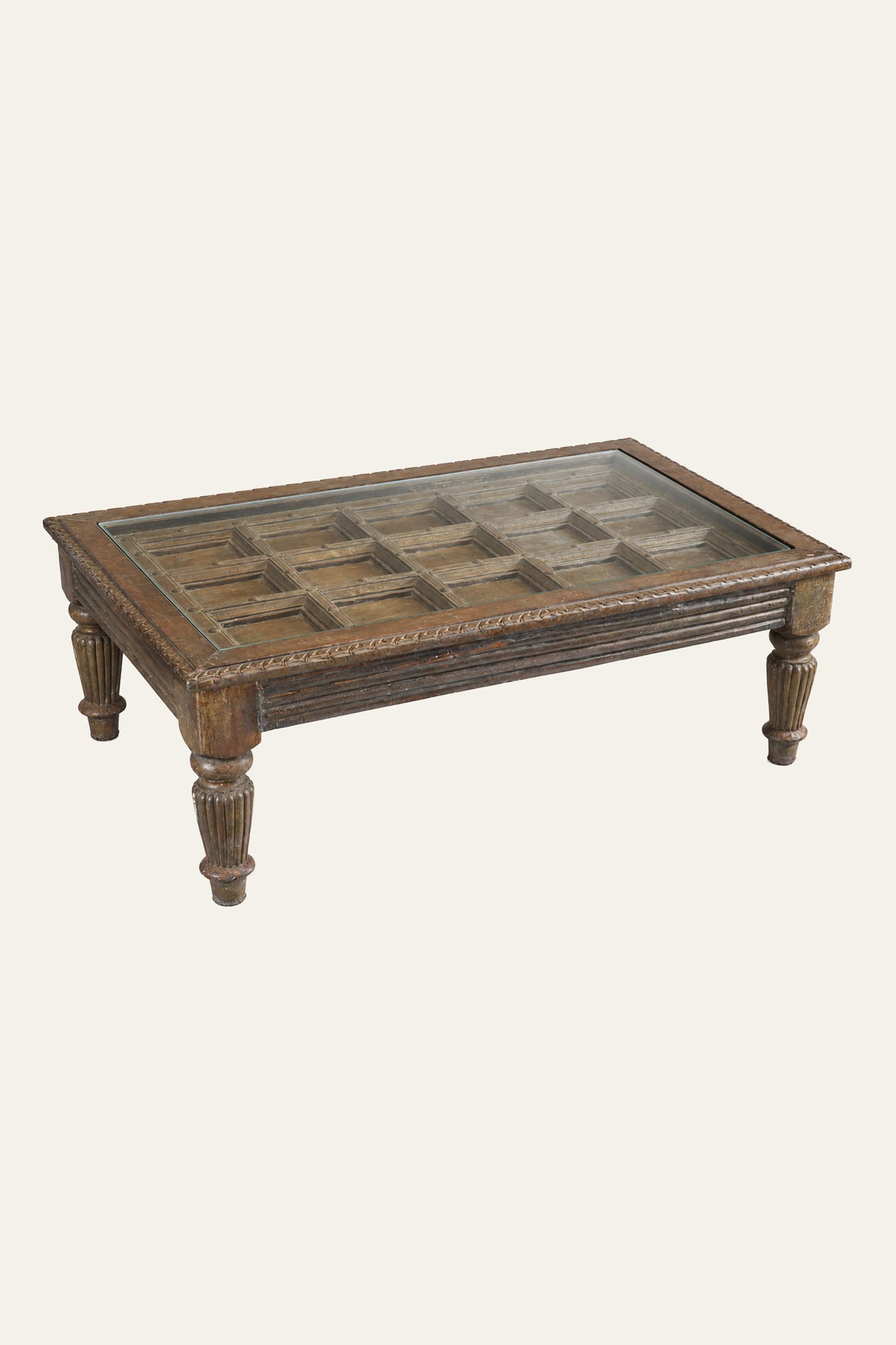 carved wooden coffee table with glass top