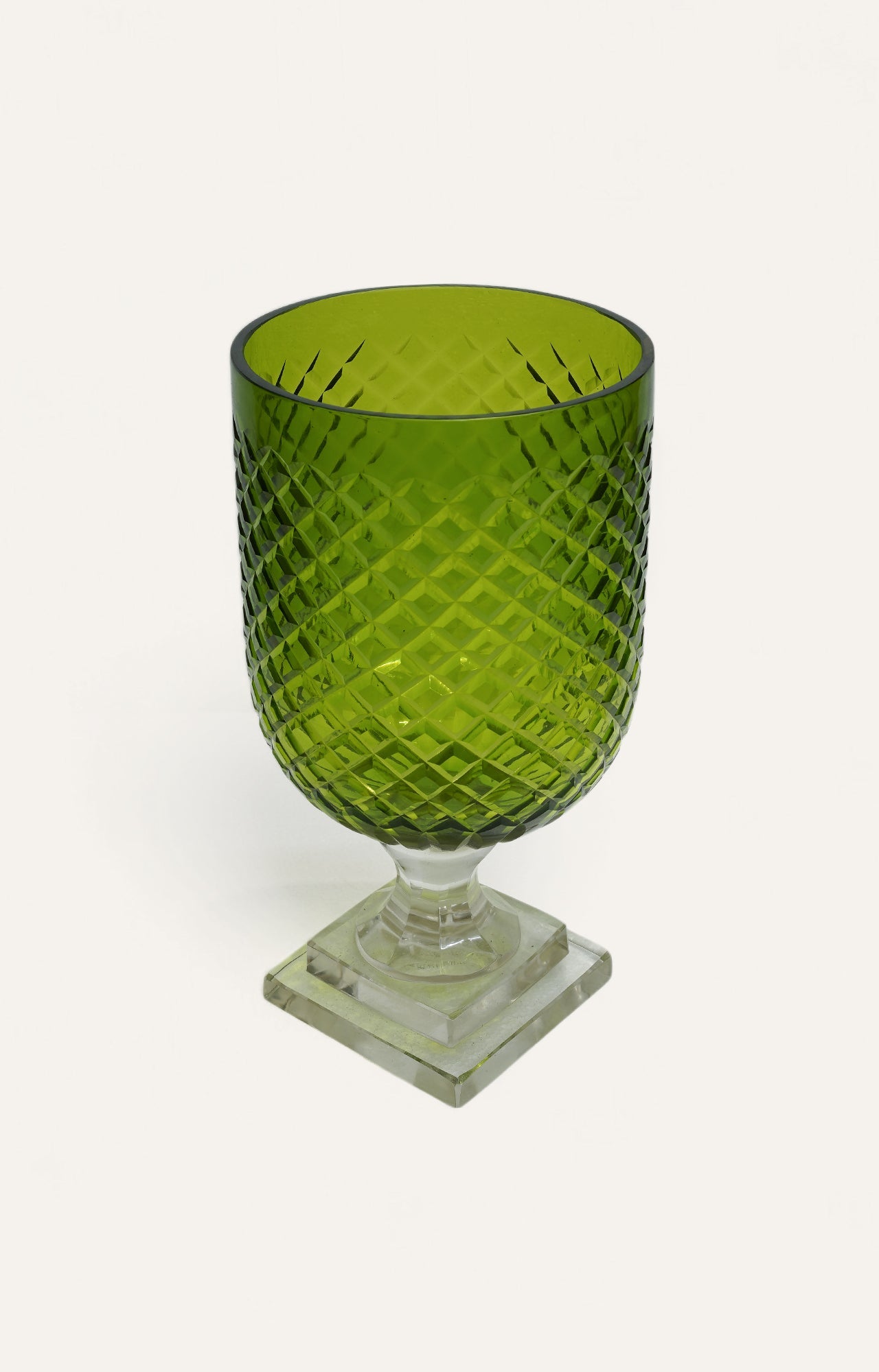 Olive green diamond-cut glass candle holder with clear pedestal base, 12 inches in height
