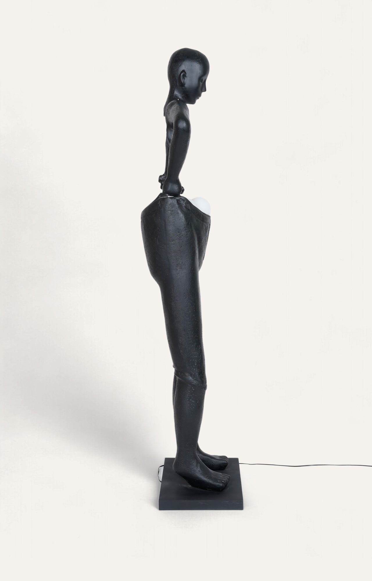 A body Sculpture Holding Floor Lamp