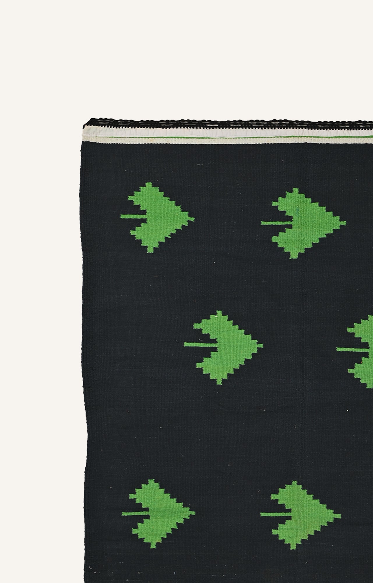 Handwoven Black rug with green spade motifs