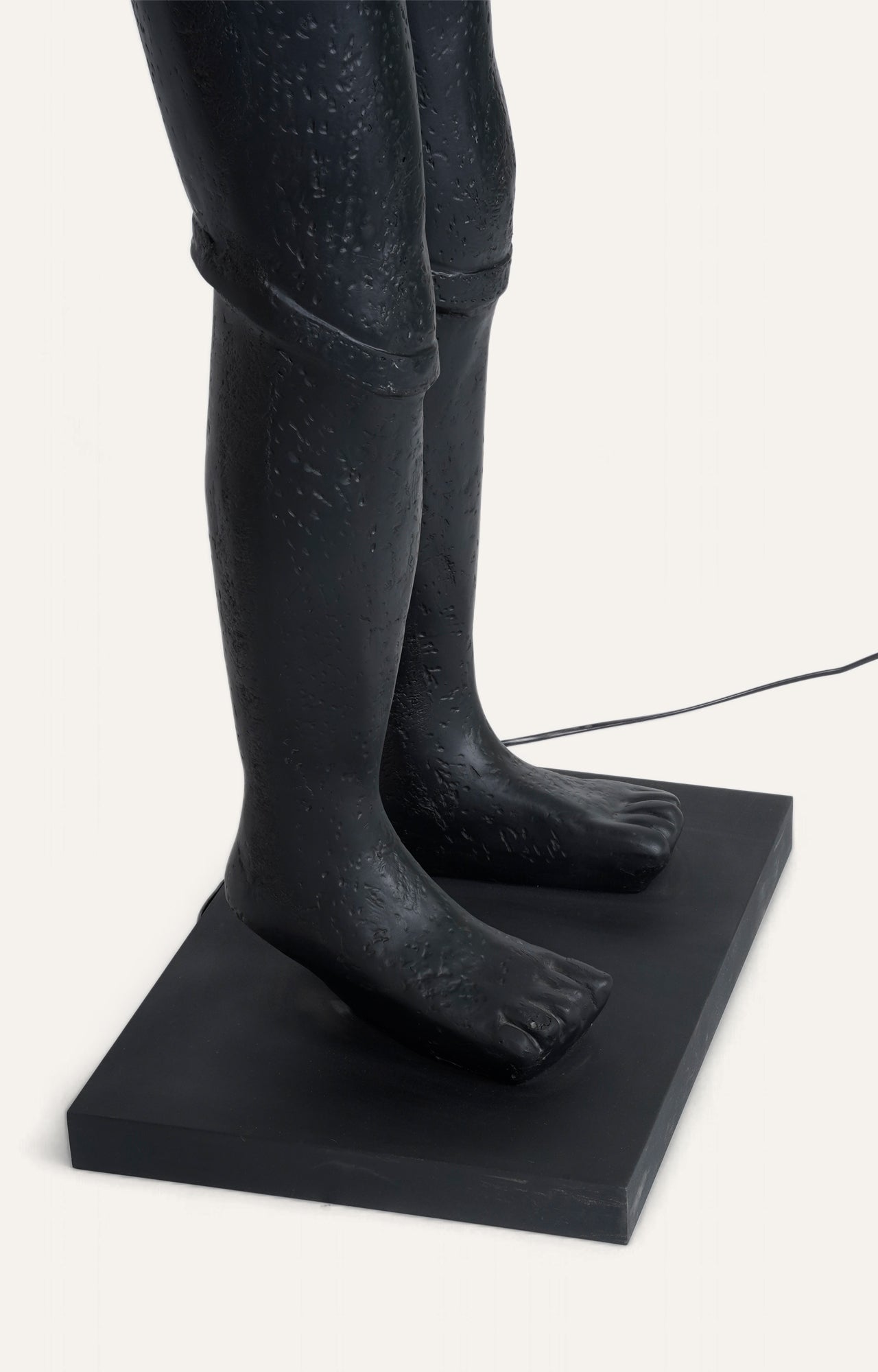 A body Sculpture Holding Floor Lamp