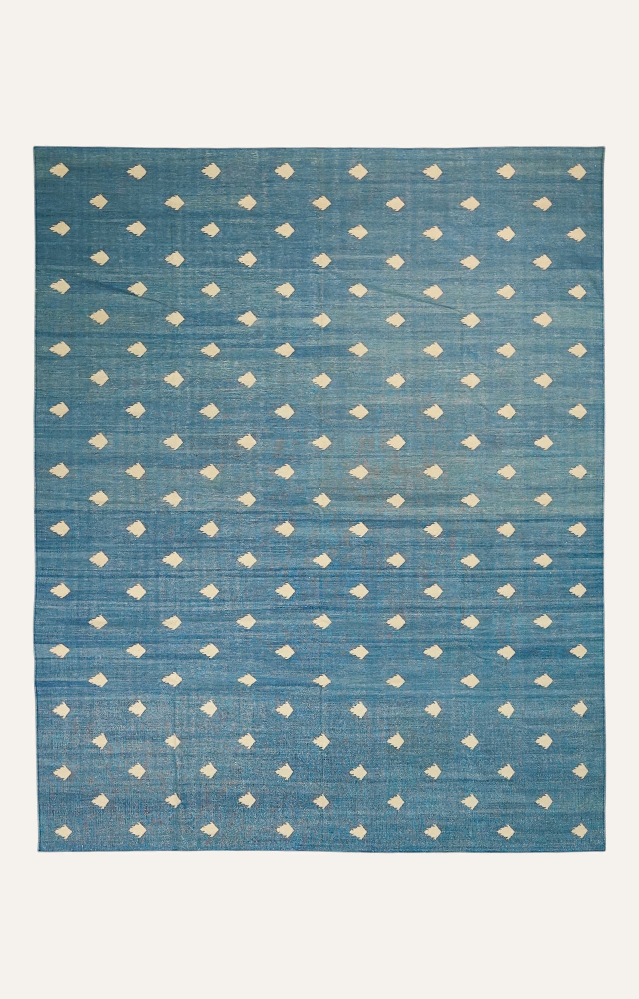 Blue rug with white geometric pattern