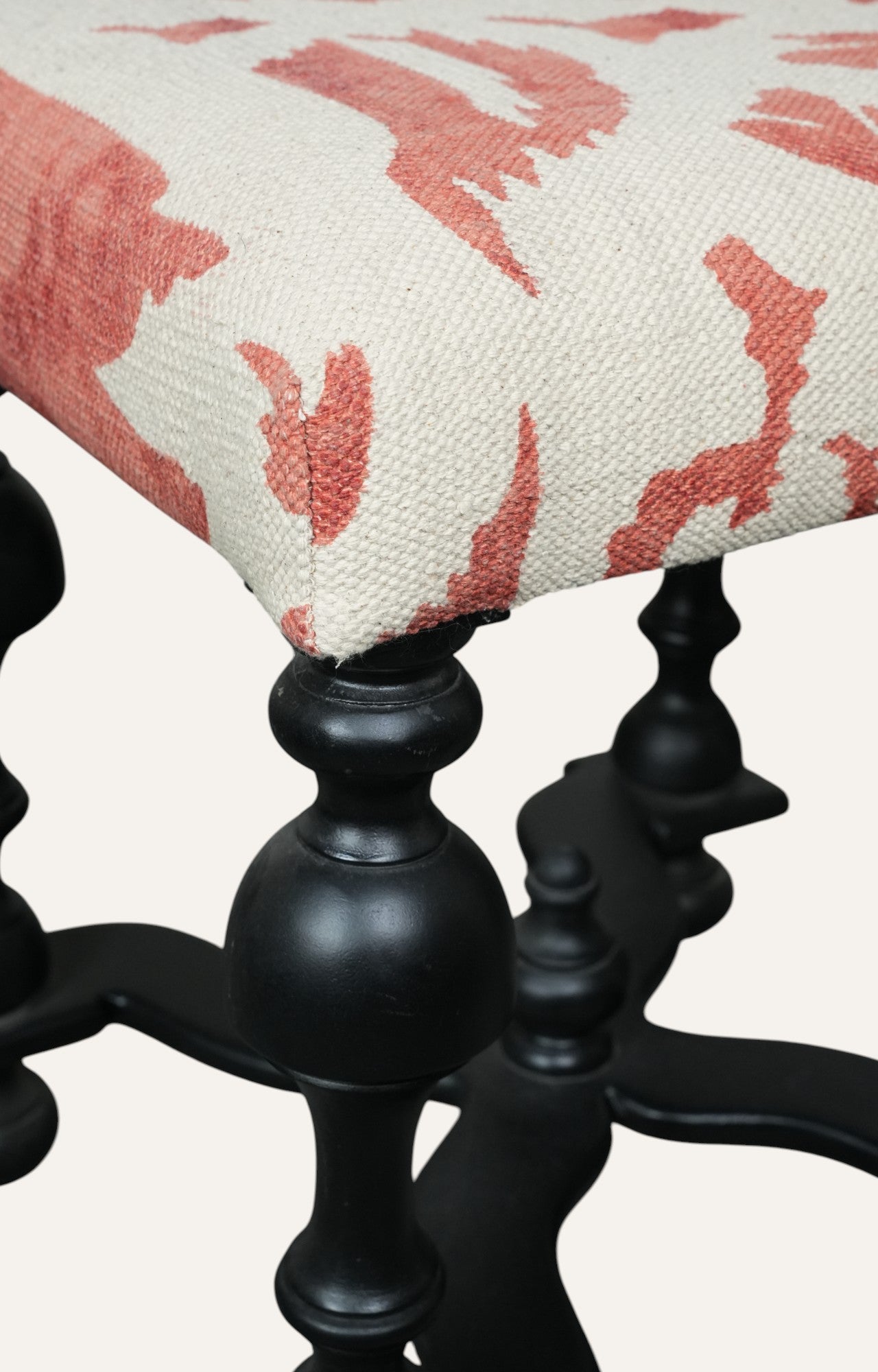 Upholstered Stool with Sculpted Black Base