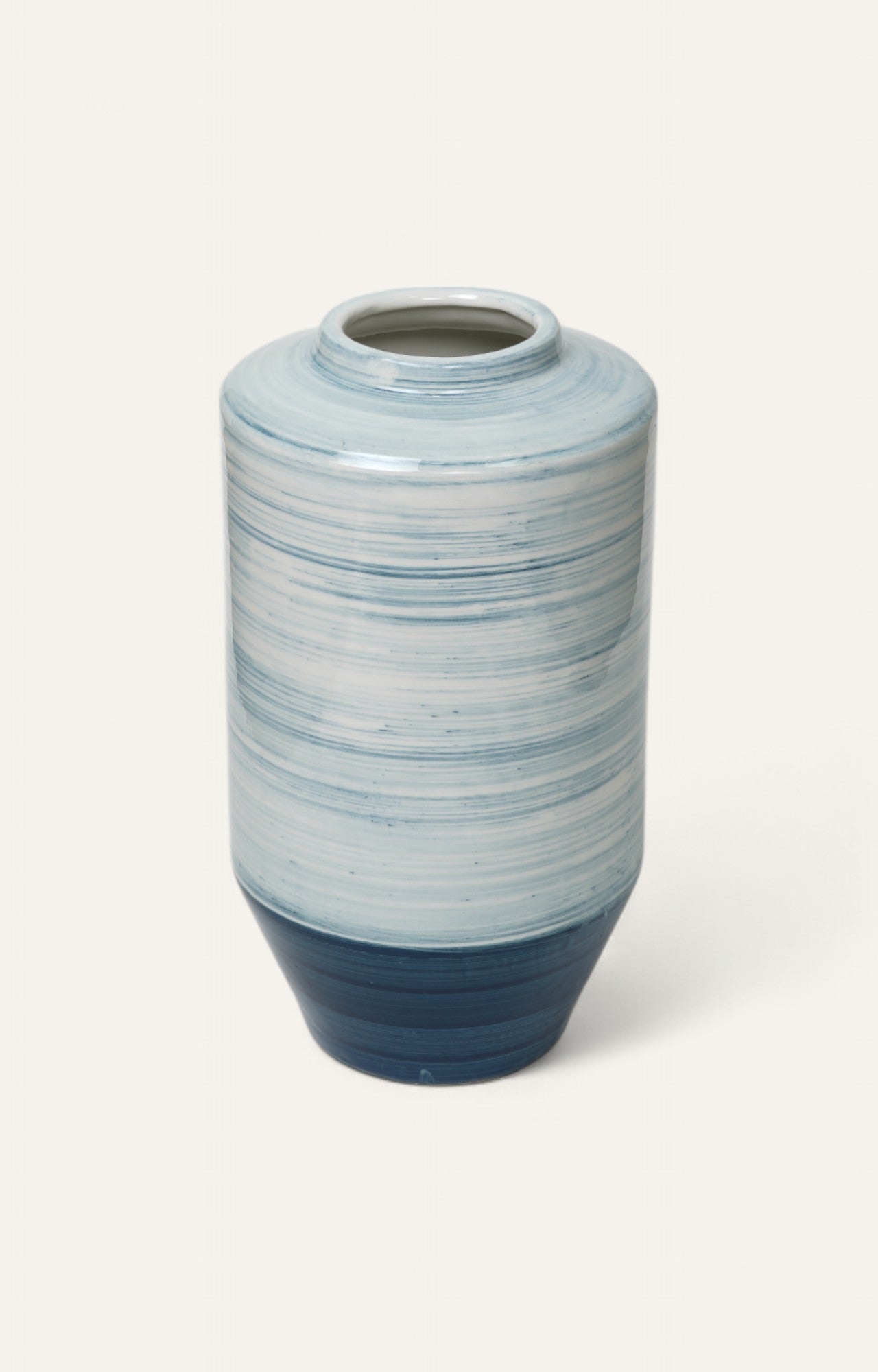 Tall ceramic vase with blue brushstroke glaze and gradient base 