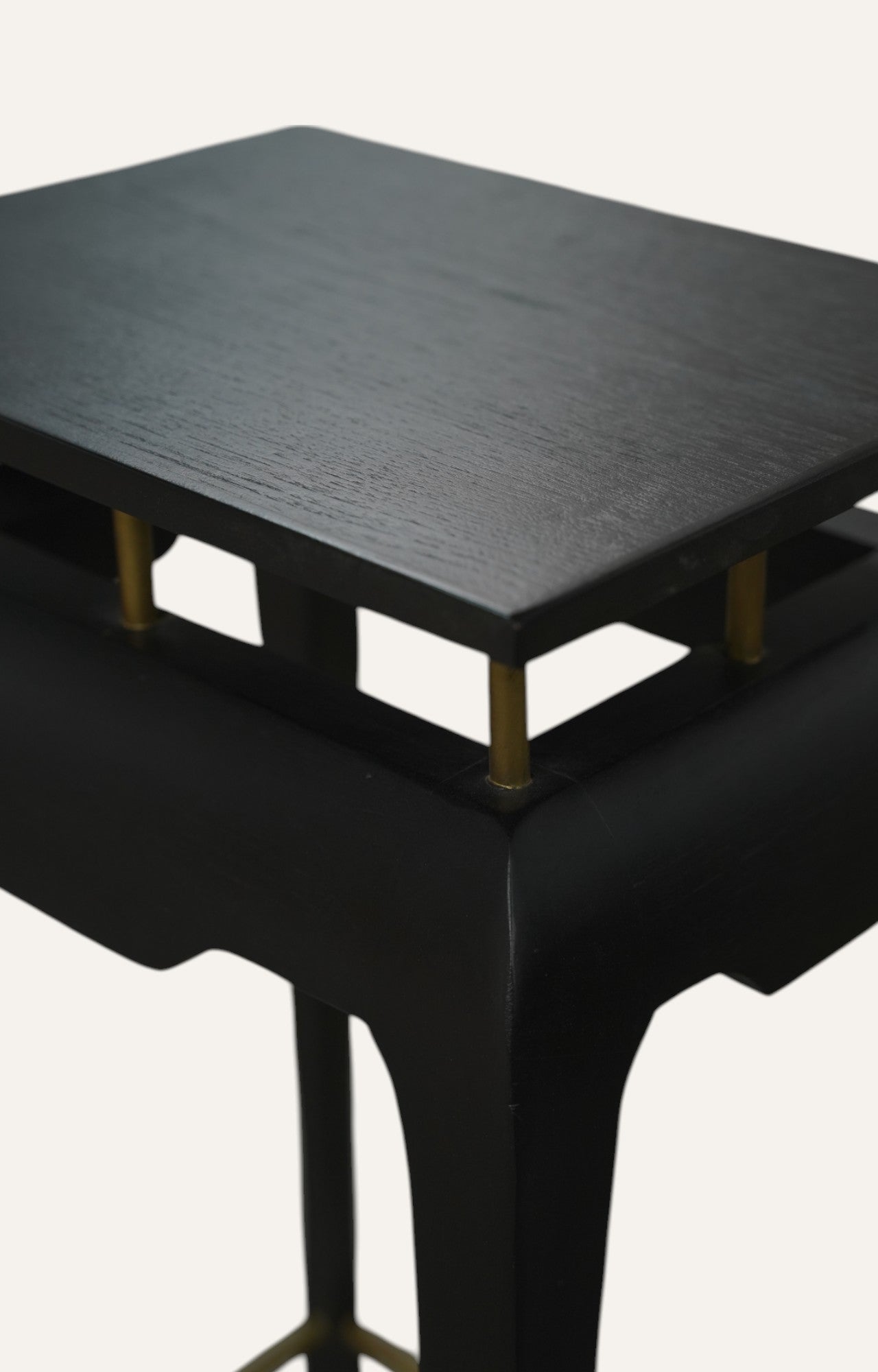 Black Sculpted Accent Table with Brass Detailing