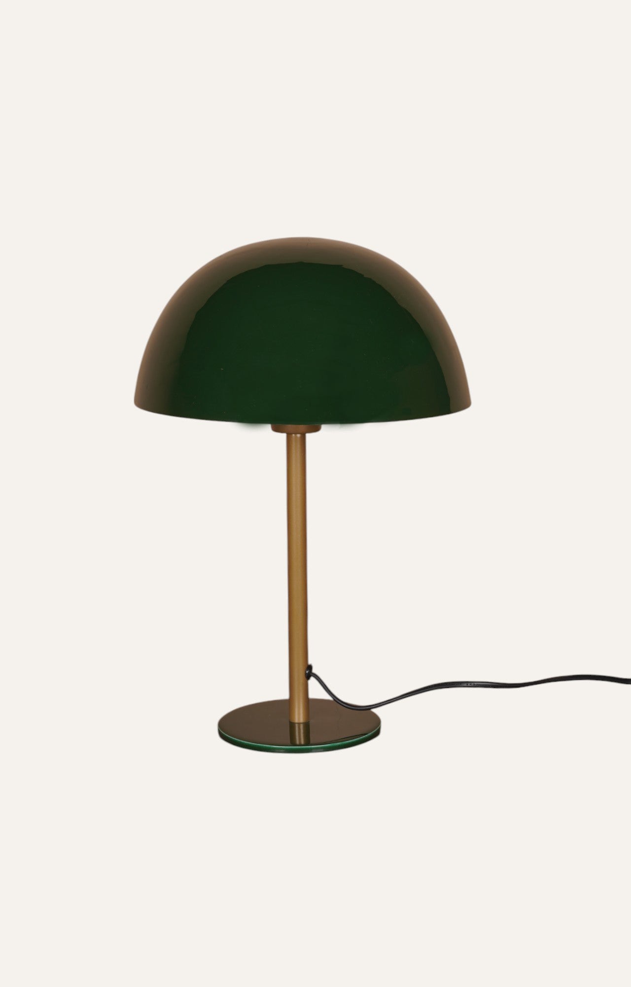 Modern table lamp with a vibrant green dome lamp shade and brass-toned accents.