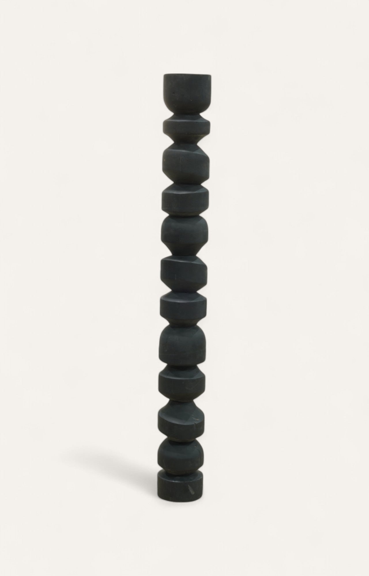 Tall black acacia wood pillar with rounded sculptural forms 