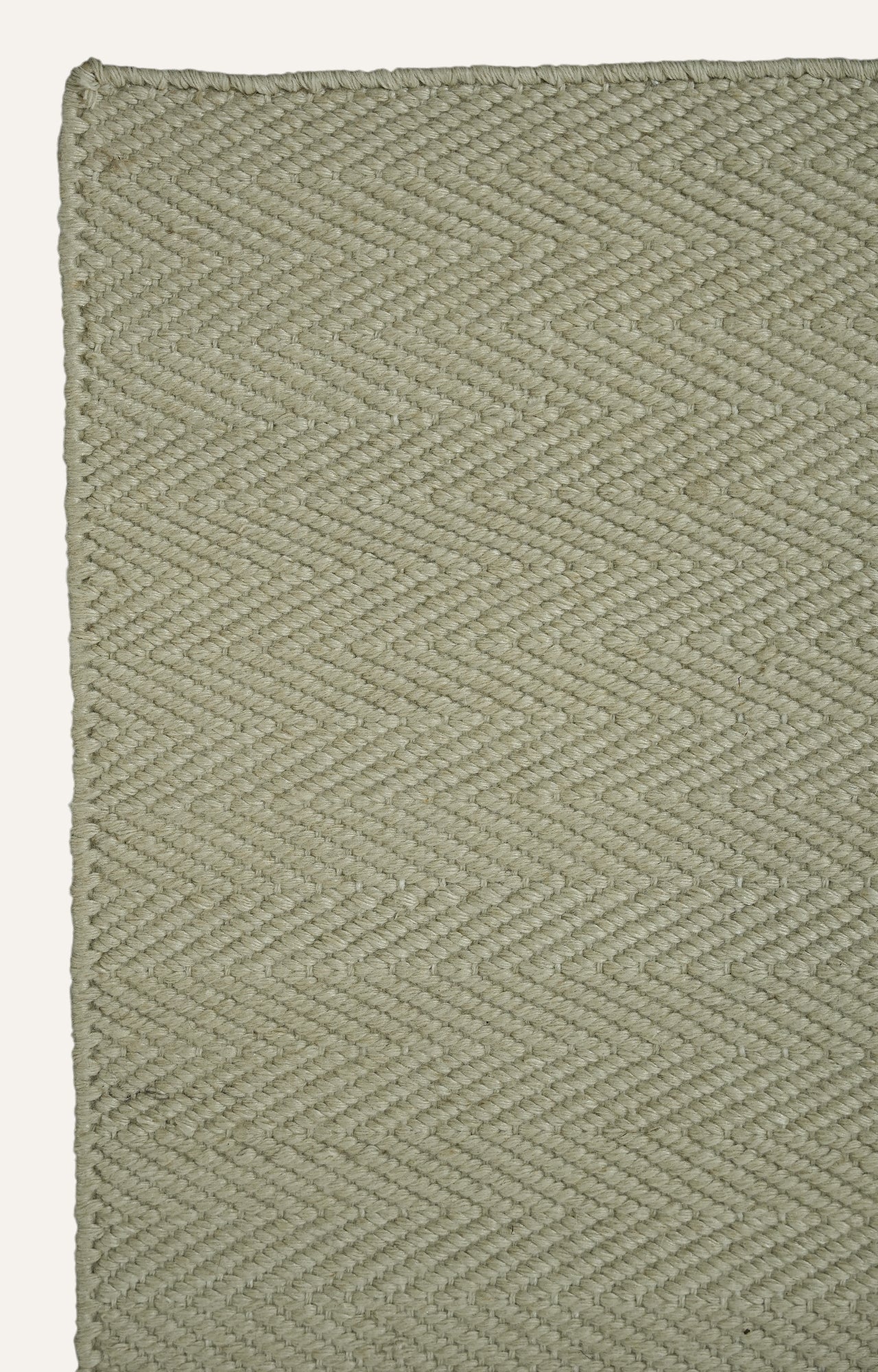 Green woven patterned rug