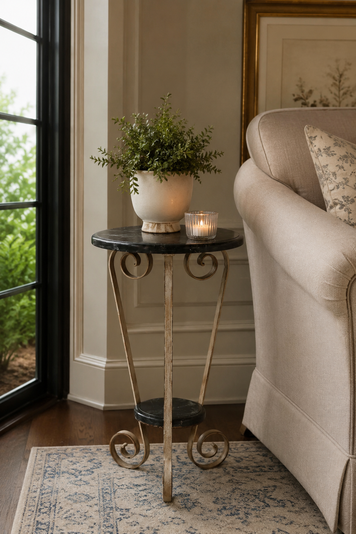 Round metal accent table with scroll base