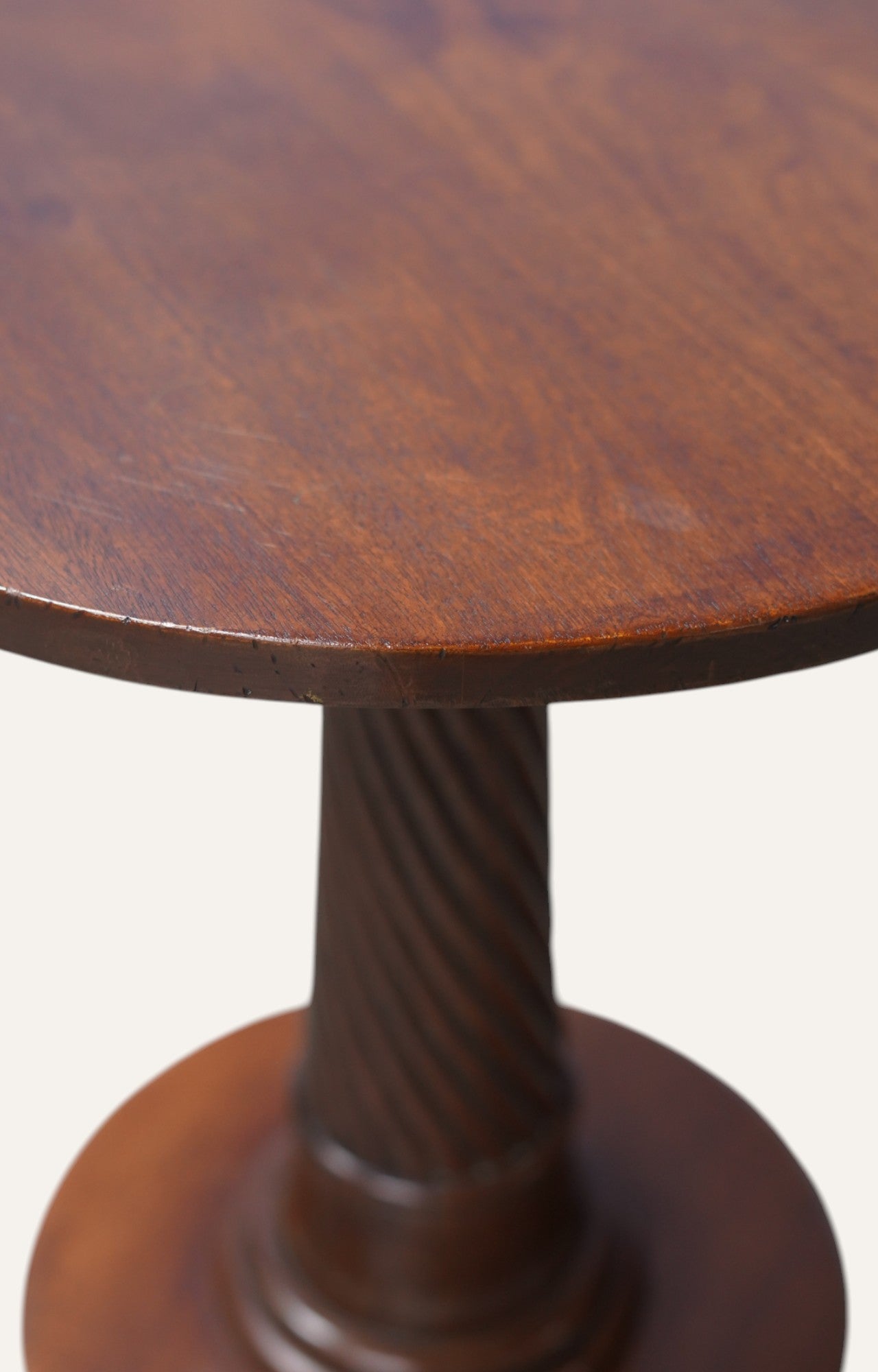 Wooden pedestal table with a round top