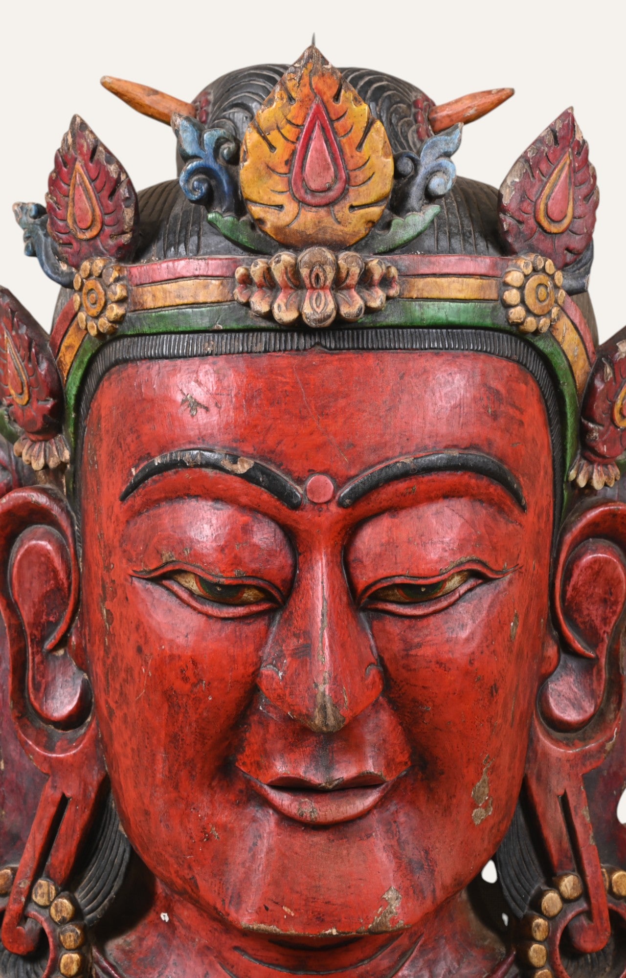 wooden mask with red face 