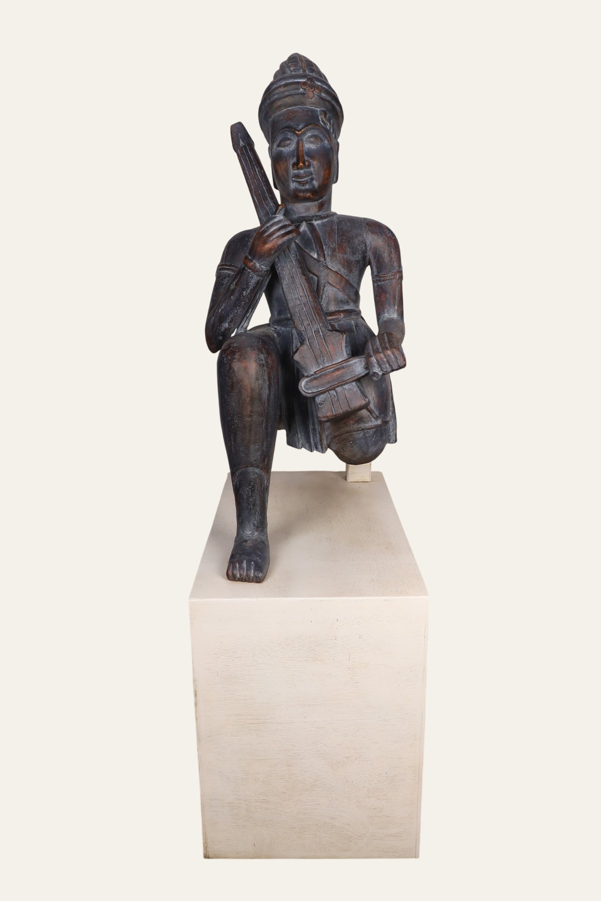 Seated Indian musician statue with aged patina