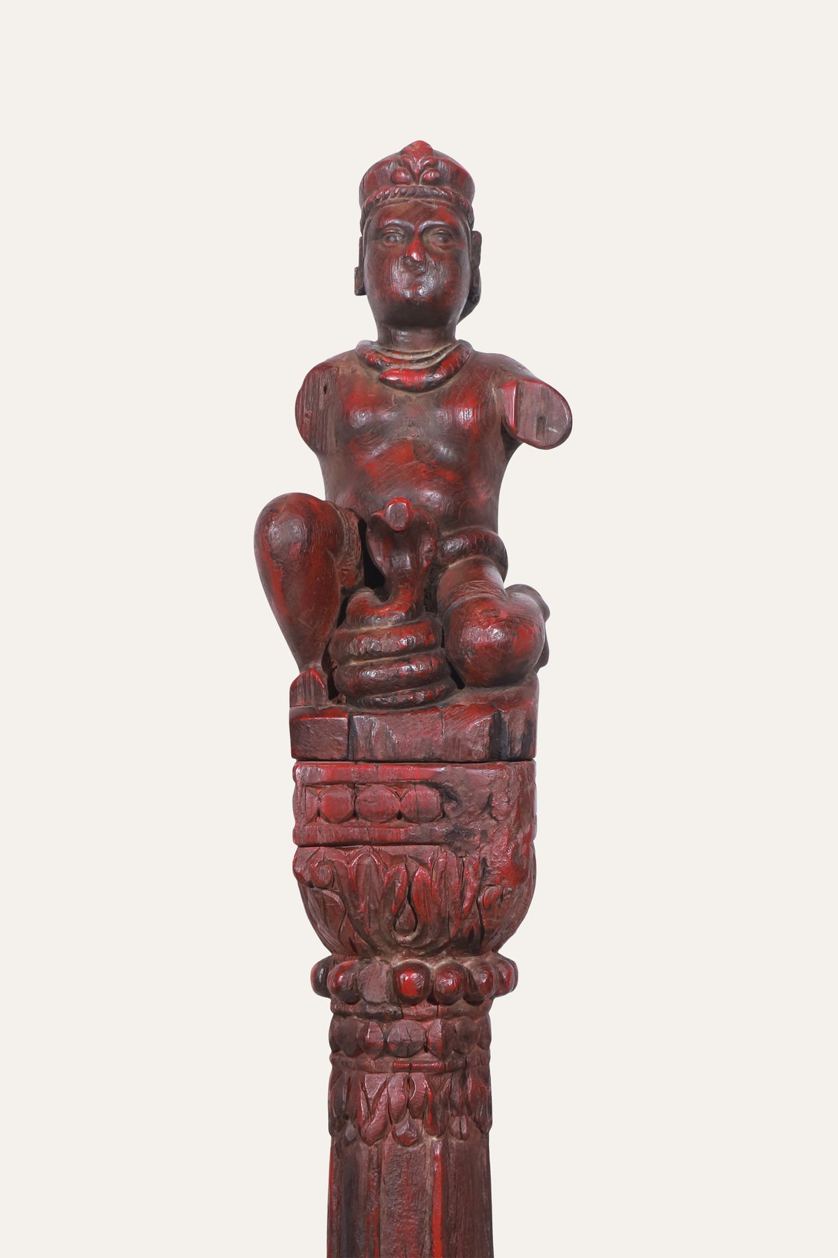 Seated deity figurine on carved column