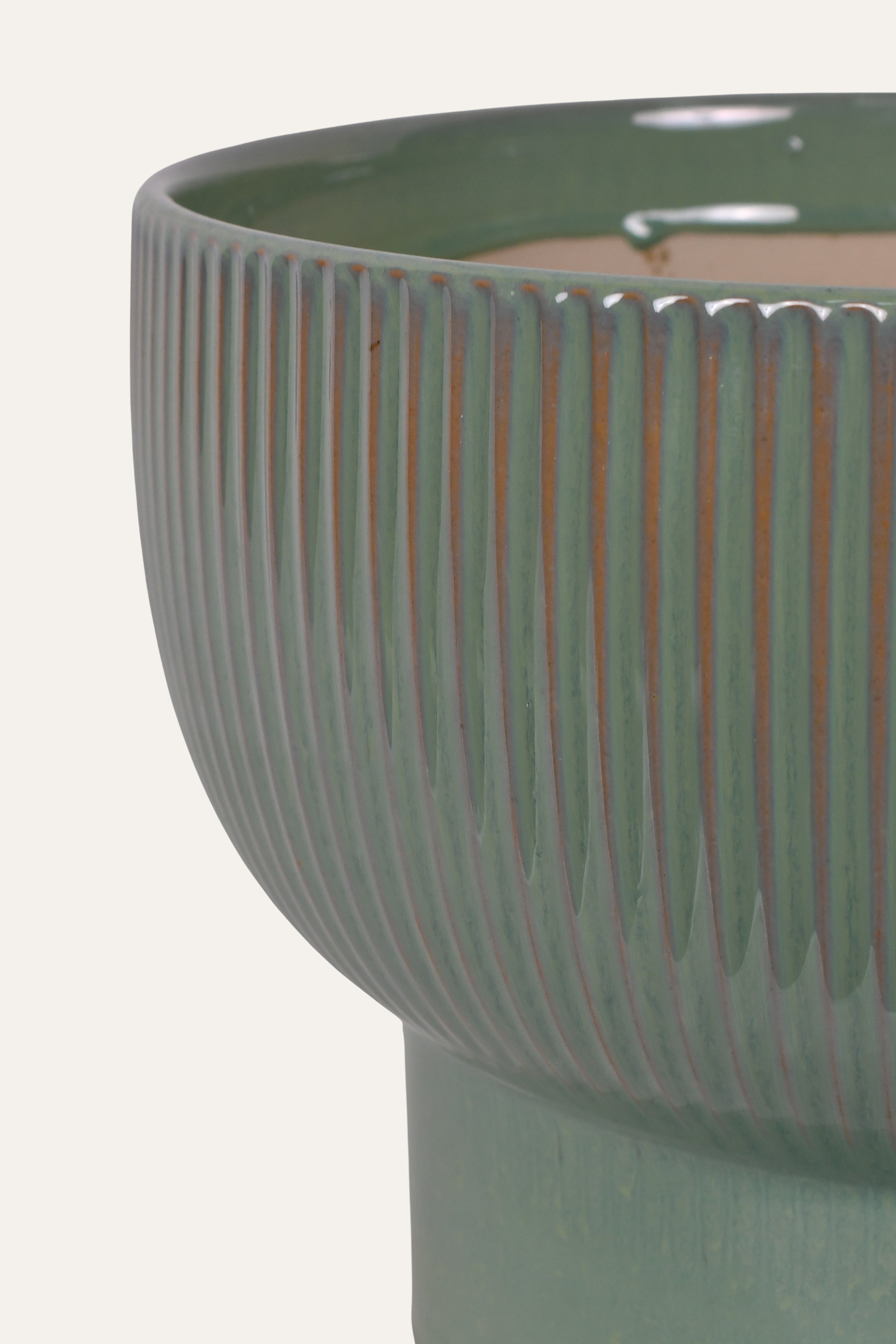Green ceramic planter with ribbed texture
