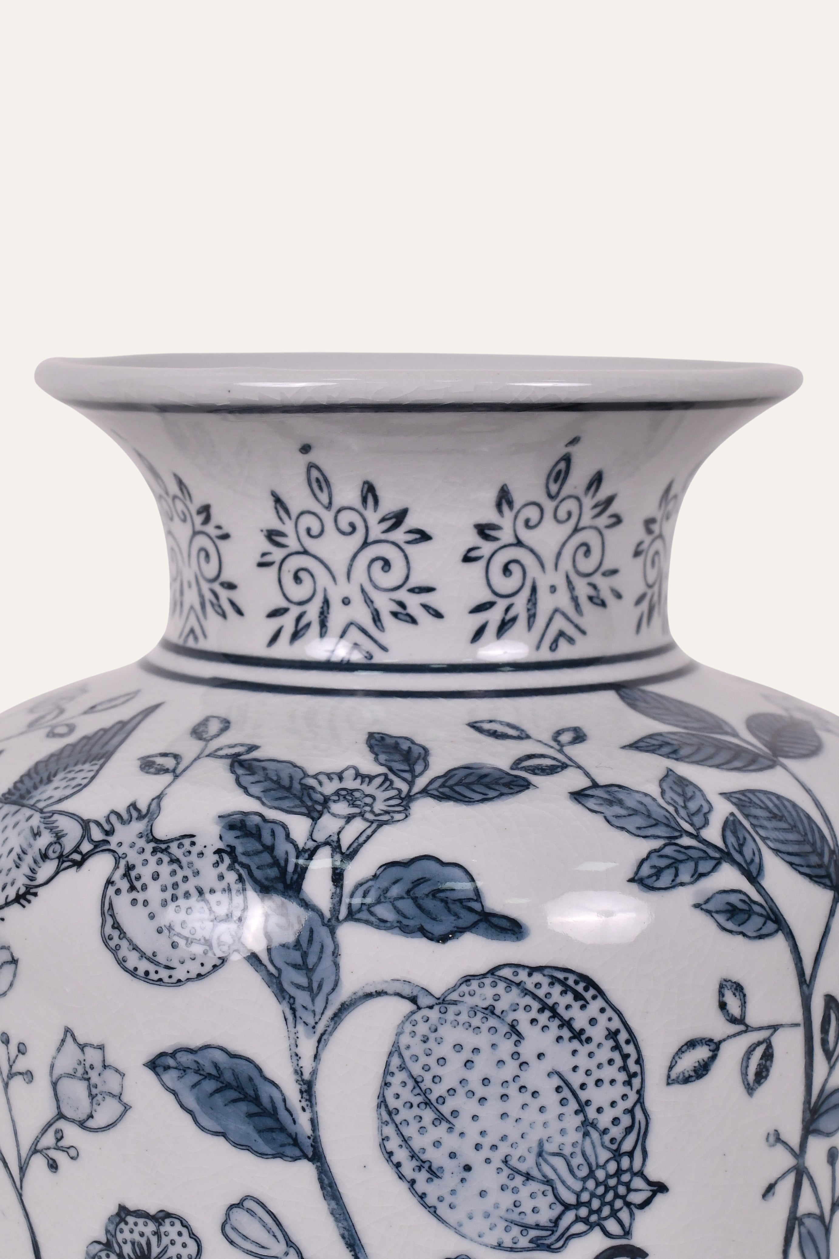 White vase with blue floral and fruit patterns