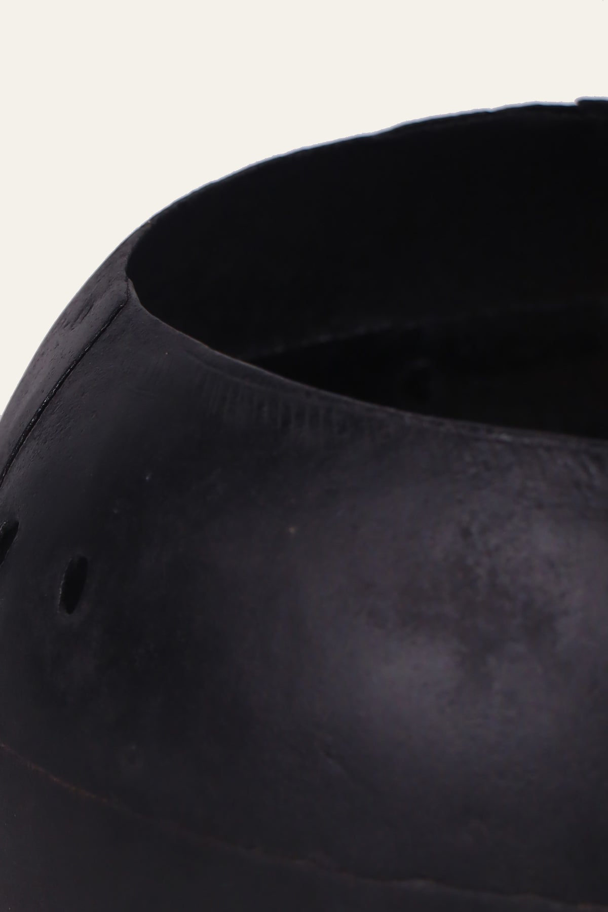 black metal pot with rivet accents