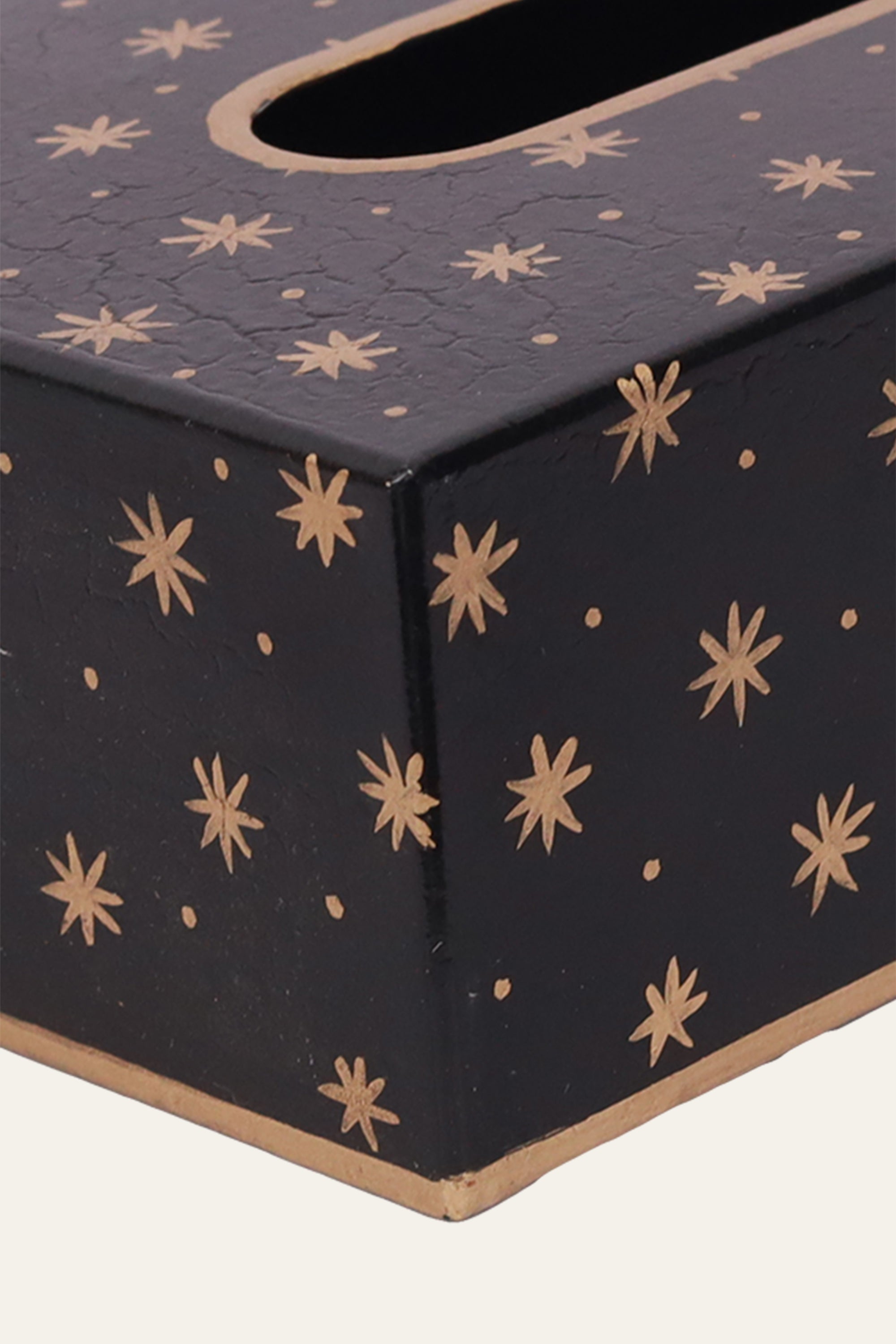 black tissue holder with gold star motifs