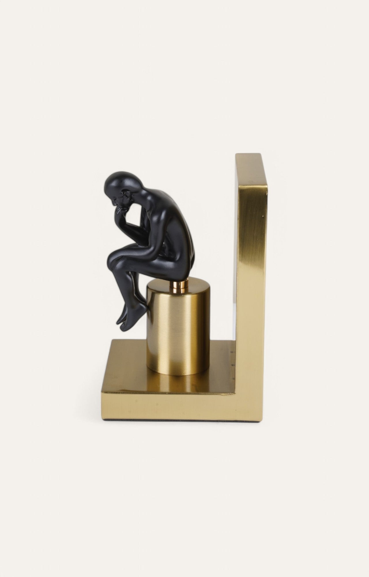 bookend with golden base and matte black figure